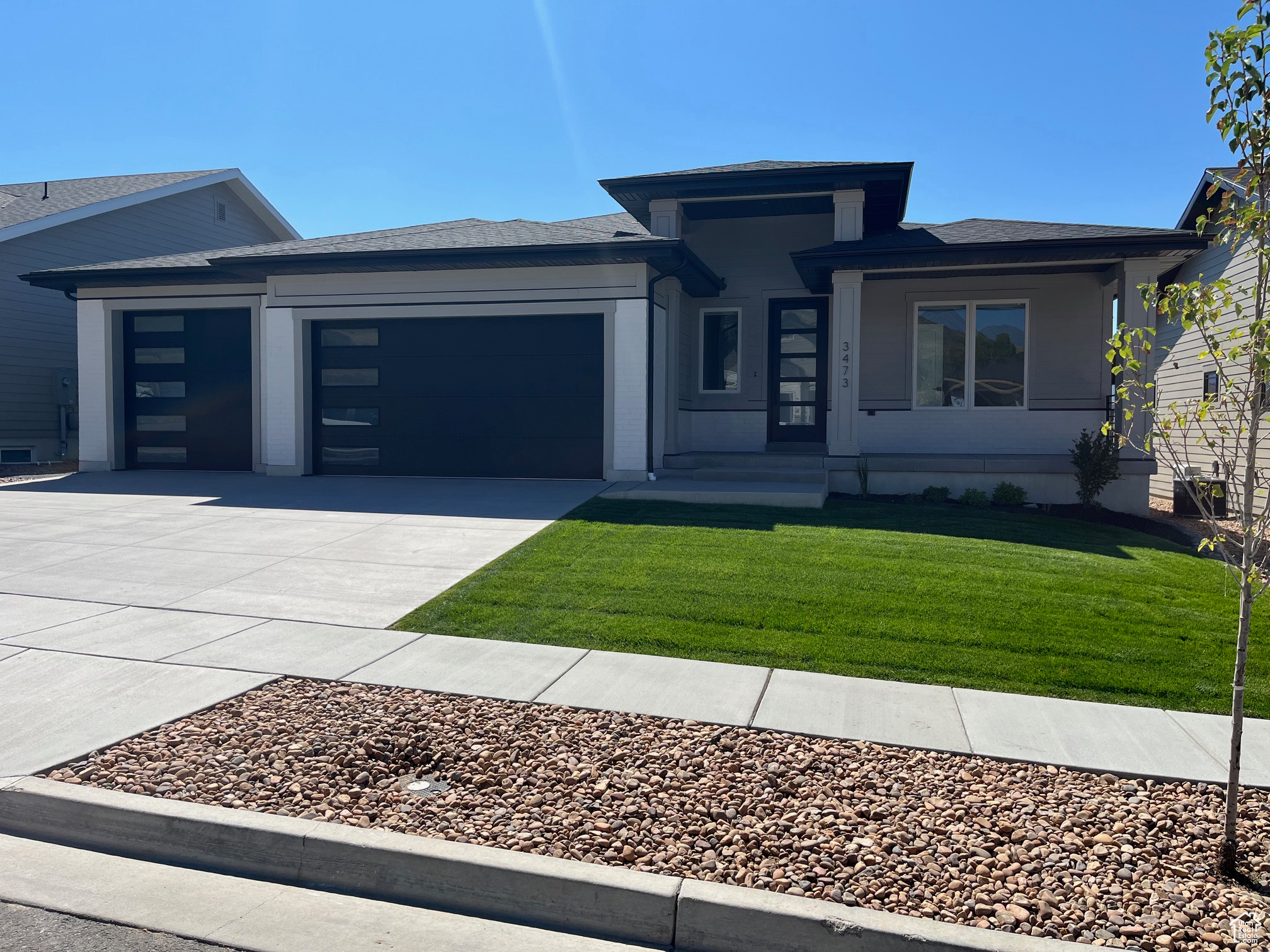 Prairie-style house featuring a front yard and a garage