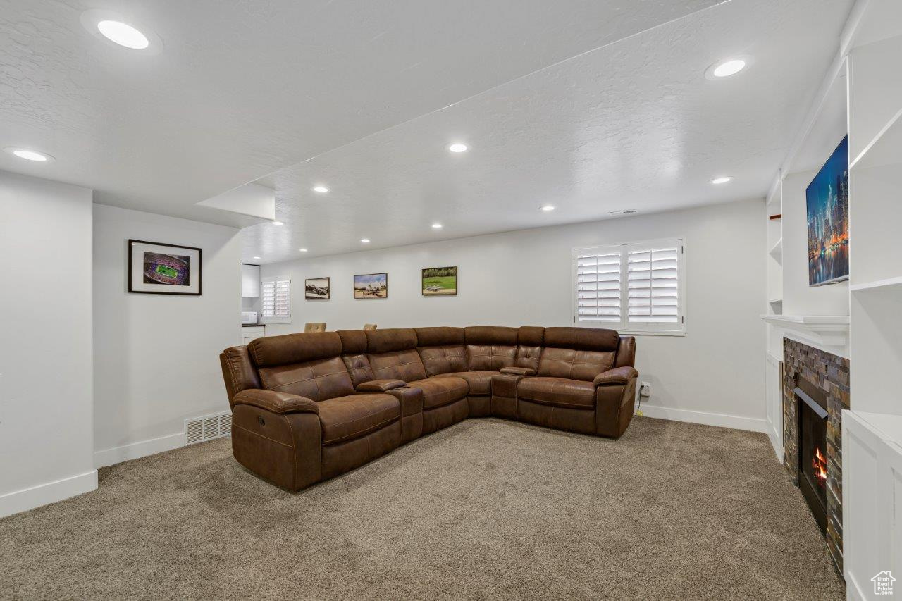 Carpeted living room with a textured ceiling