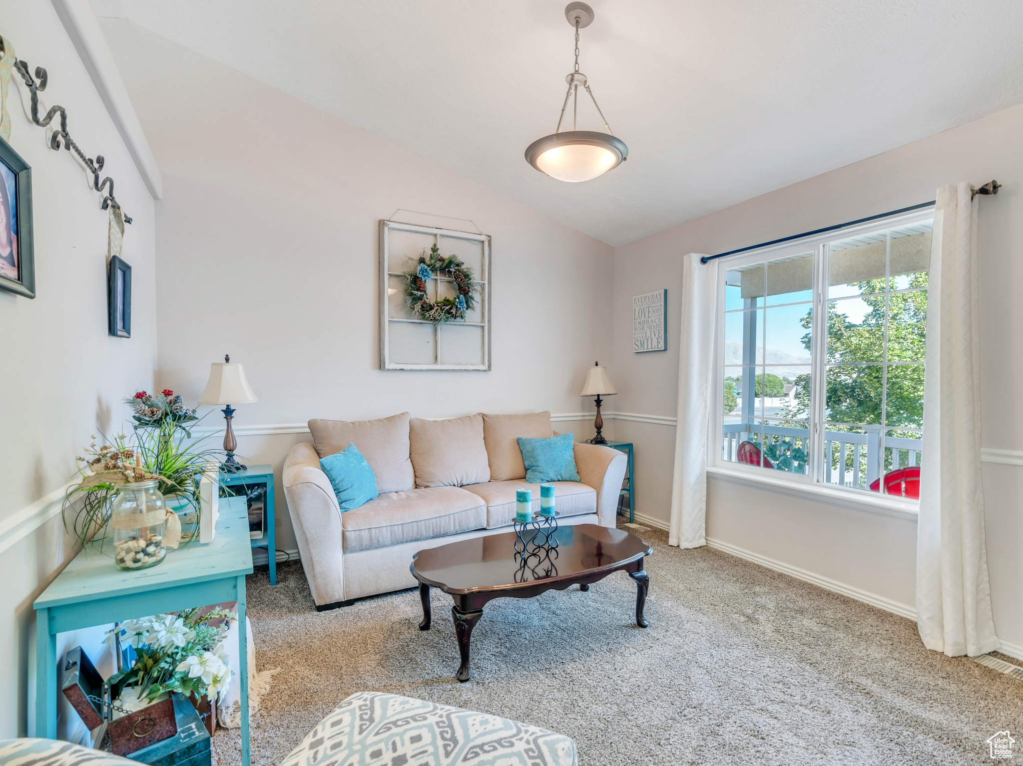 Carpeted living room with vaulted ceiling