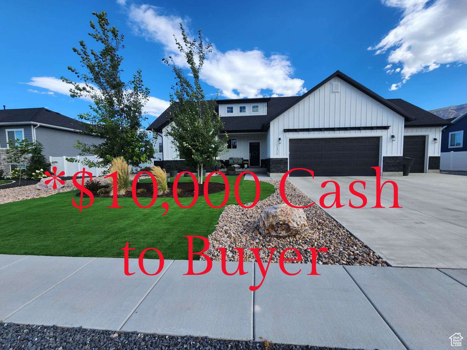 View of front of property with a garage and a front lawn