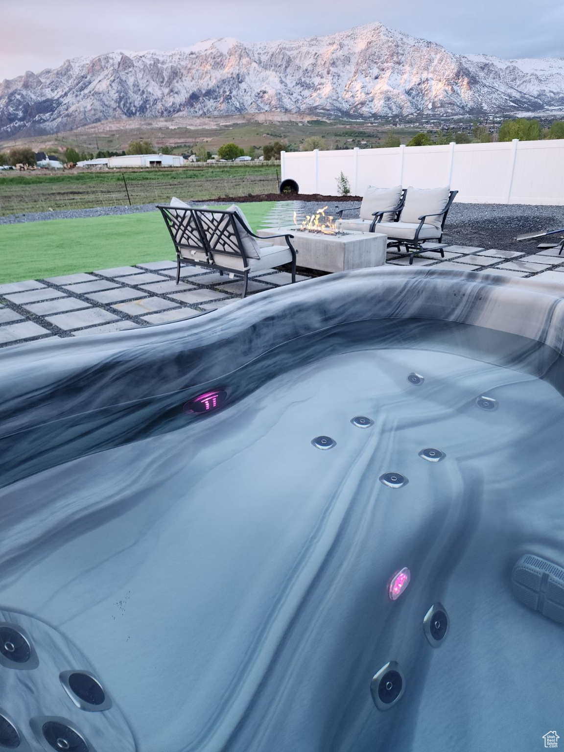 Exterior details with a hot tub and a mountain view