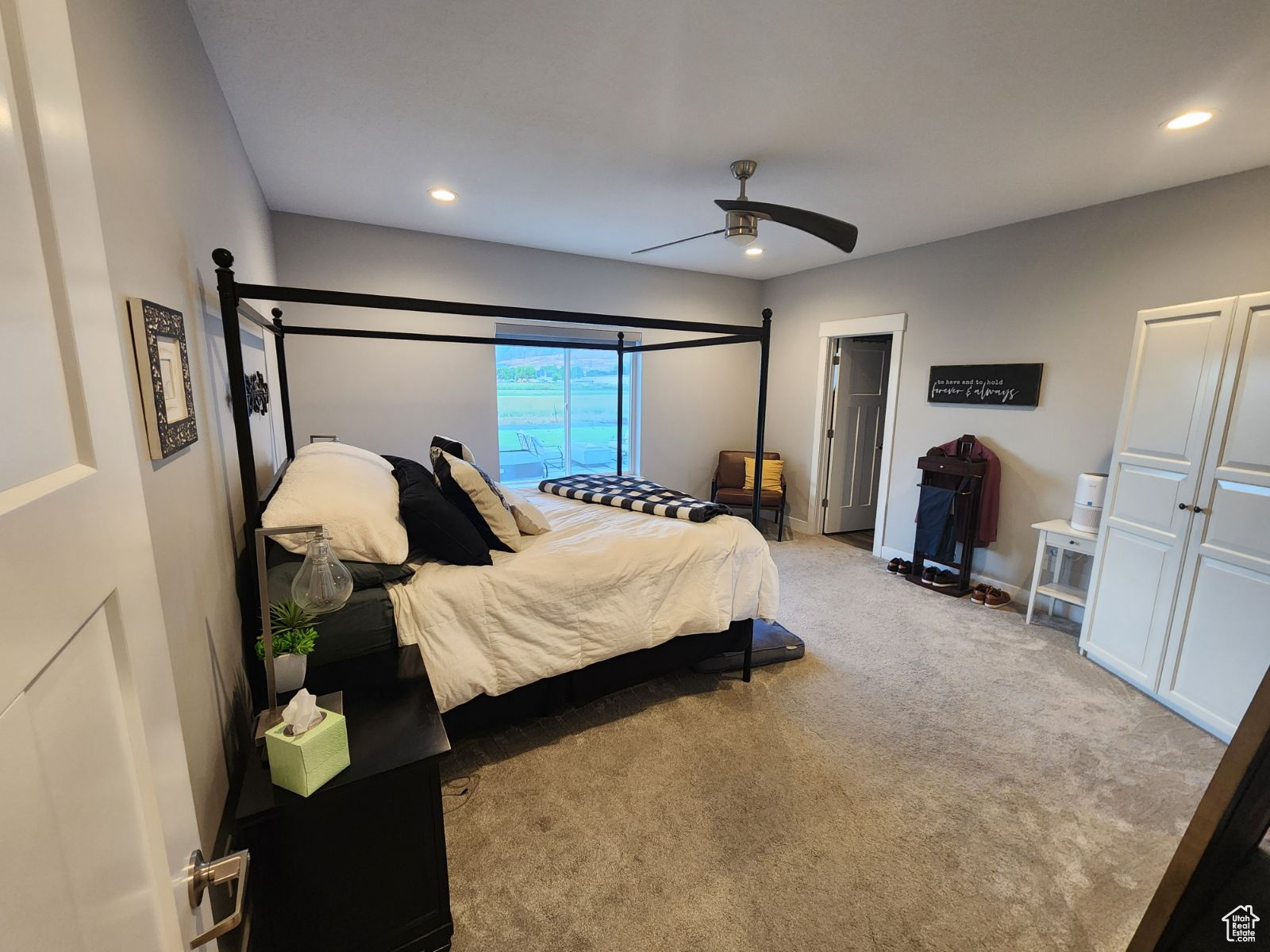 Carpeted bedroom with ceiling fan