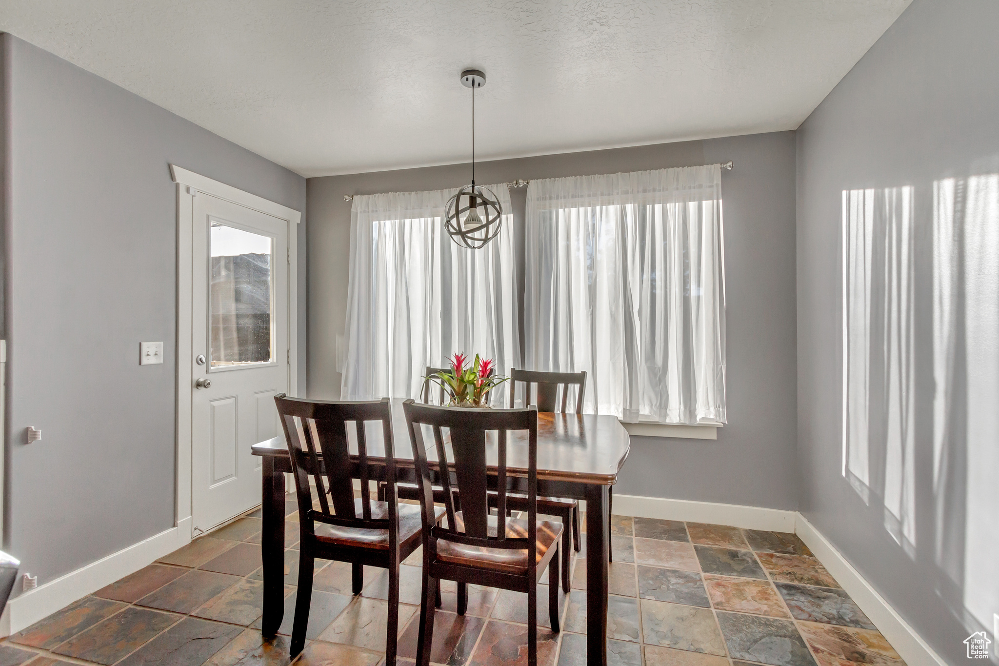 Dining space with dark tile patterned flooring