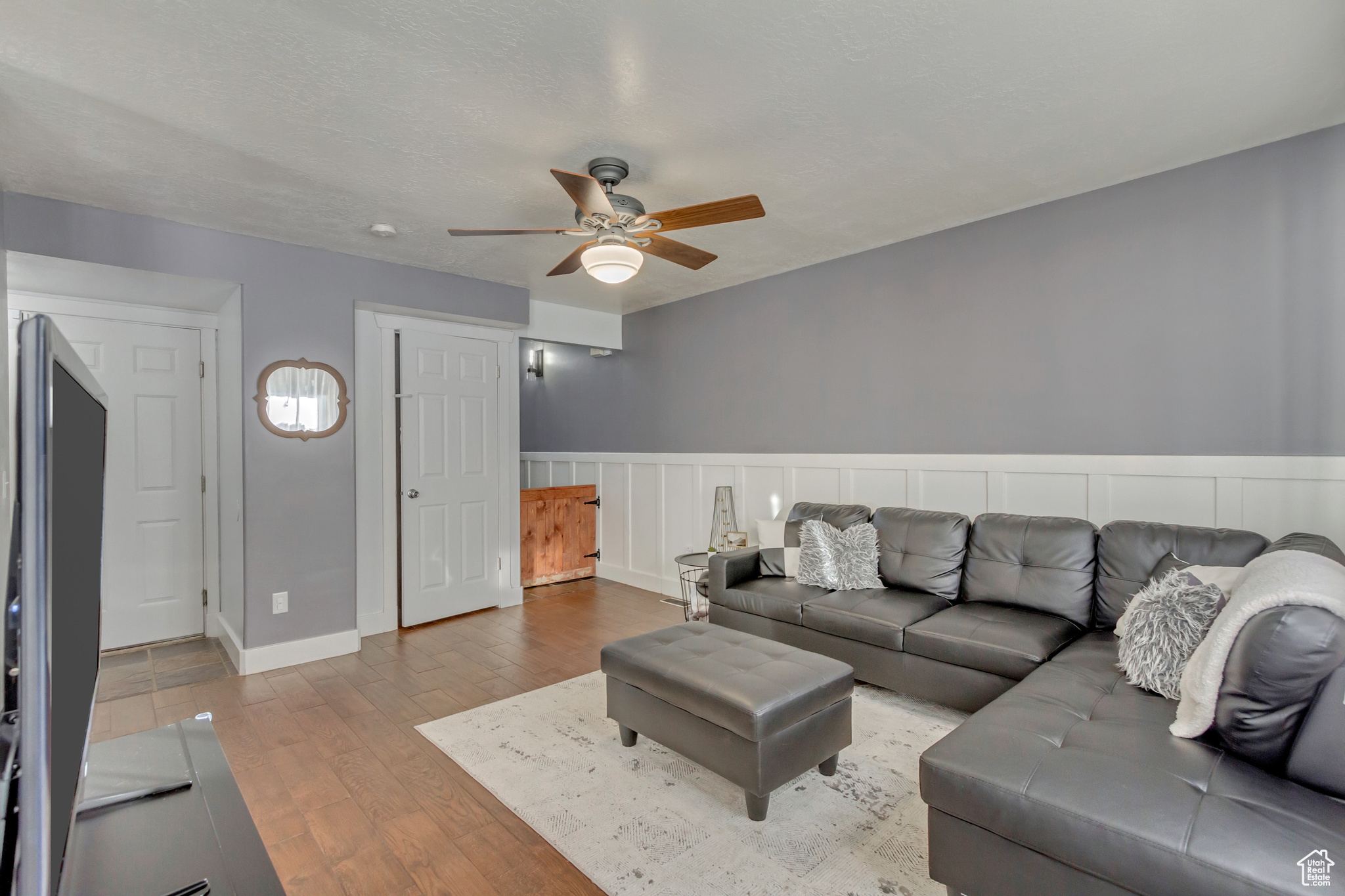 Living room featuring ceiling fan and hardwood / wood-style floors