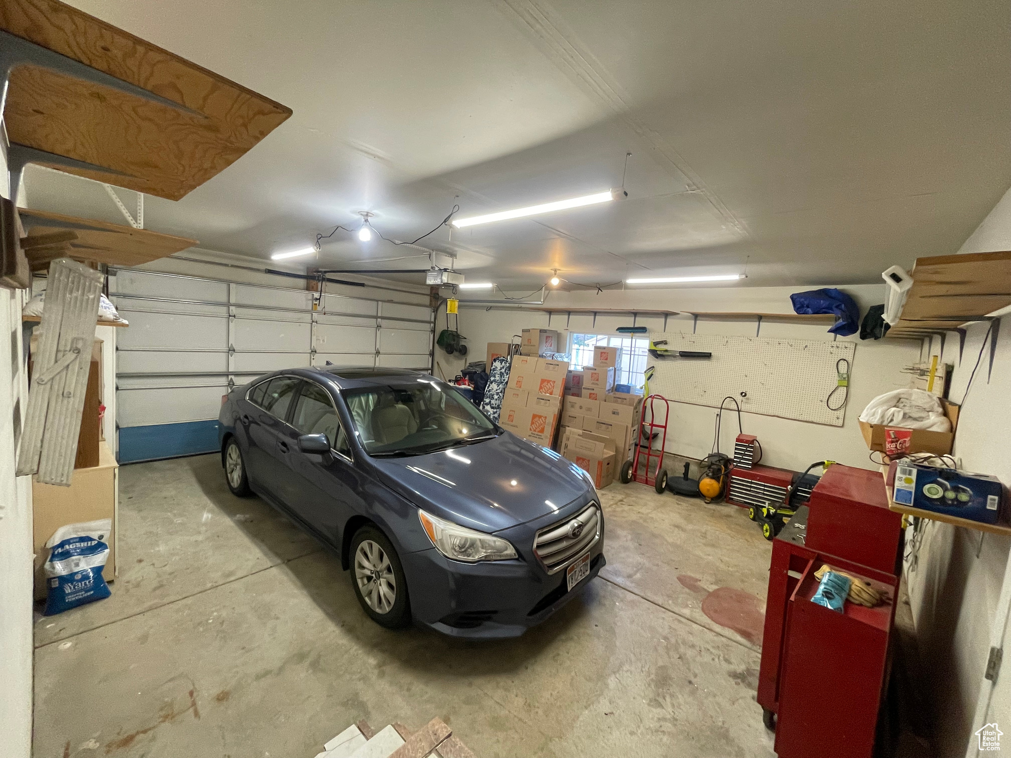 Extra Length and fits 2 vehicles. Well illuminated with bright lights and storage cabinets also shelving  on brackets already attached.