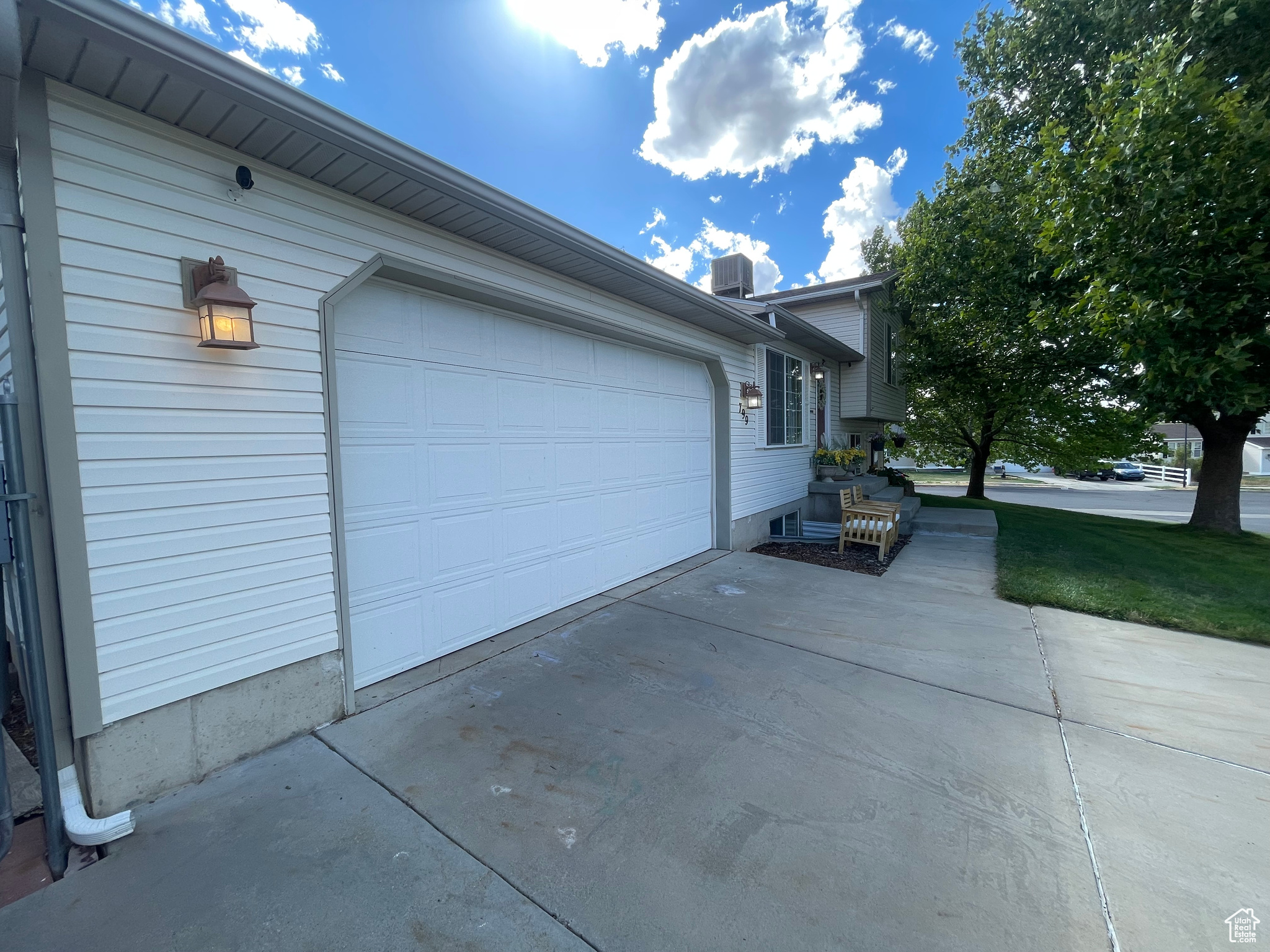 Double garage door with exterior lighting and security cameras.
