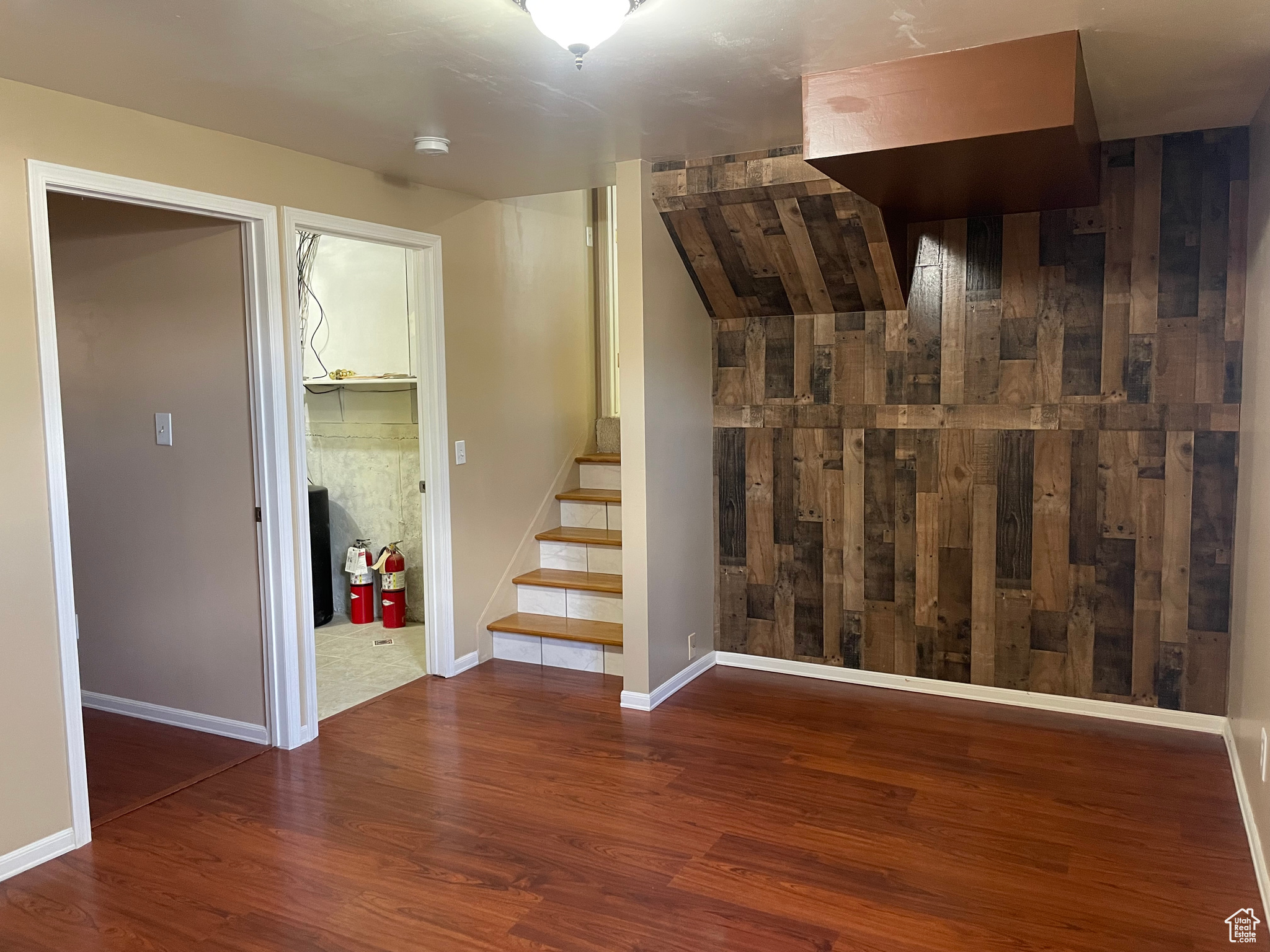 The wall has a wood veneer for the barn look, love it keep it, don't then it can easily  be removed.