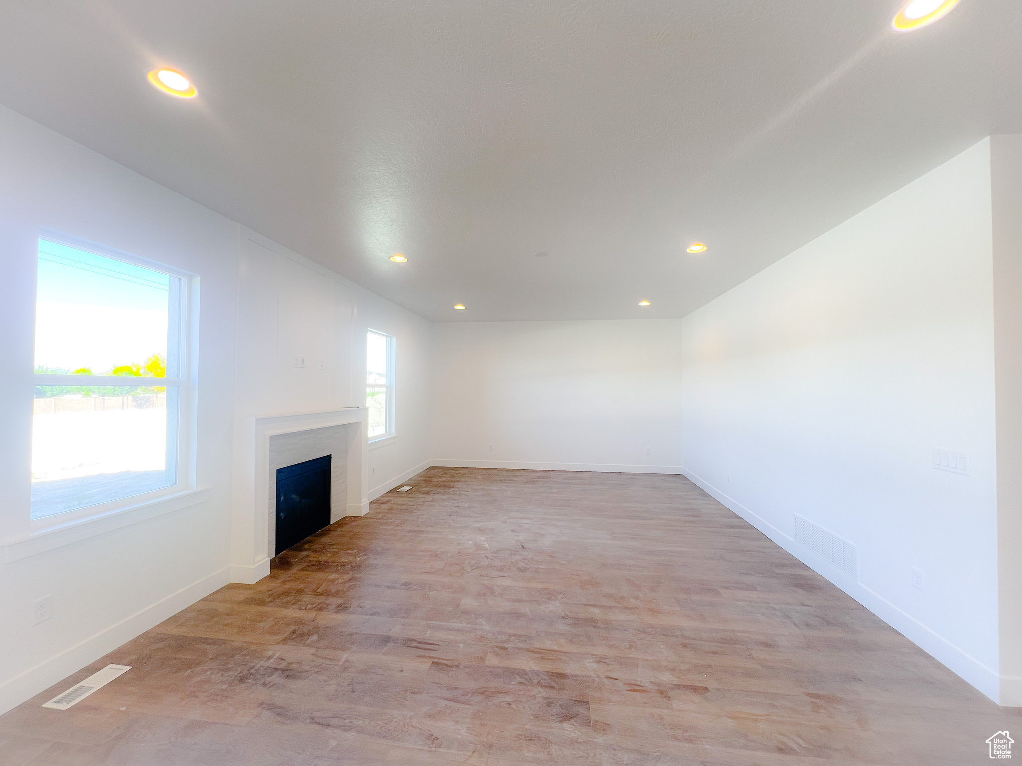 Unfurnished living room featuring light wood-type flooring