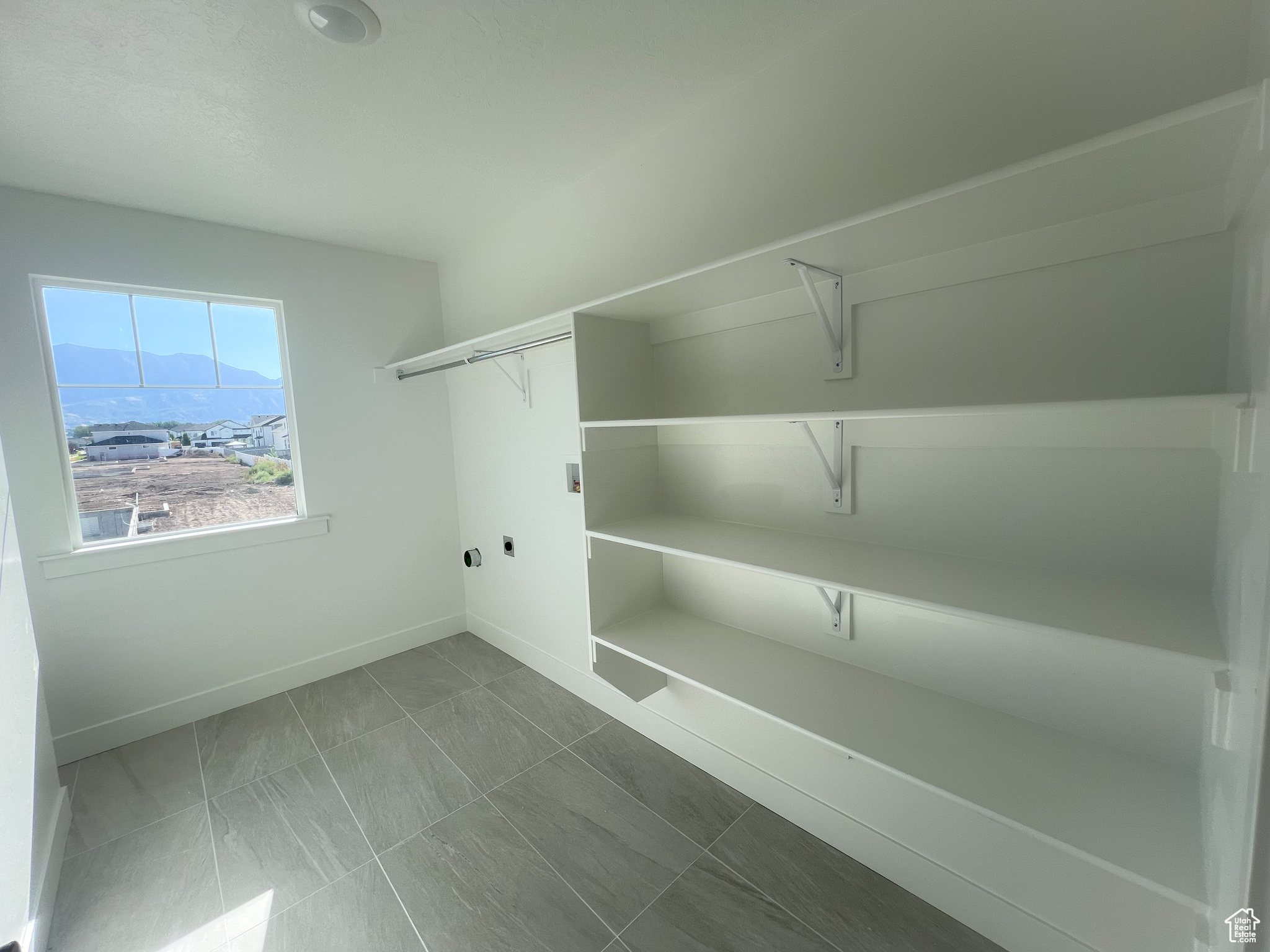 Spacious closet featuring tile patterned flooring