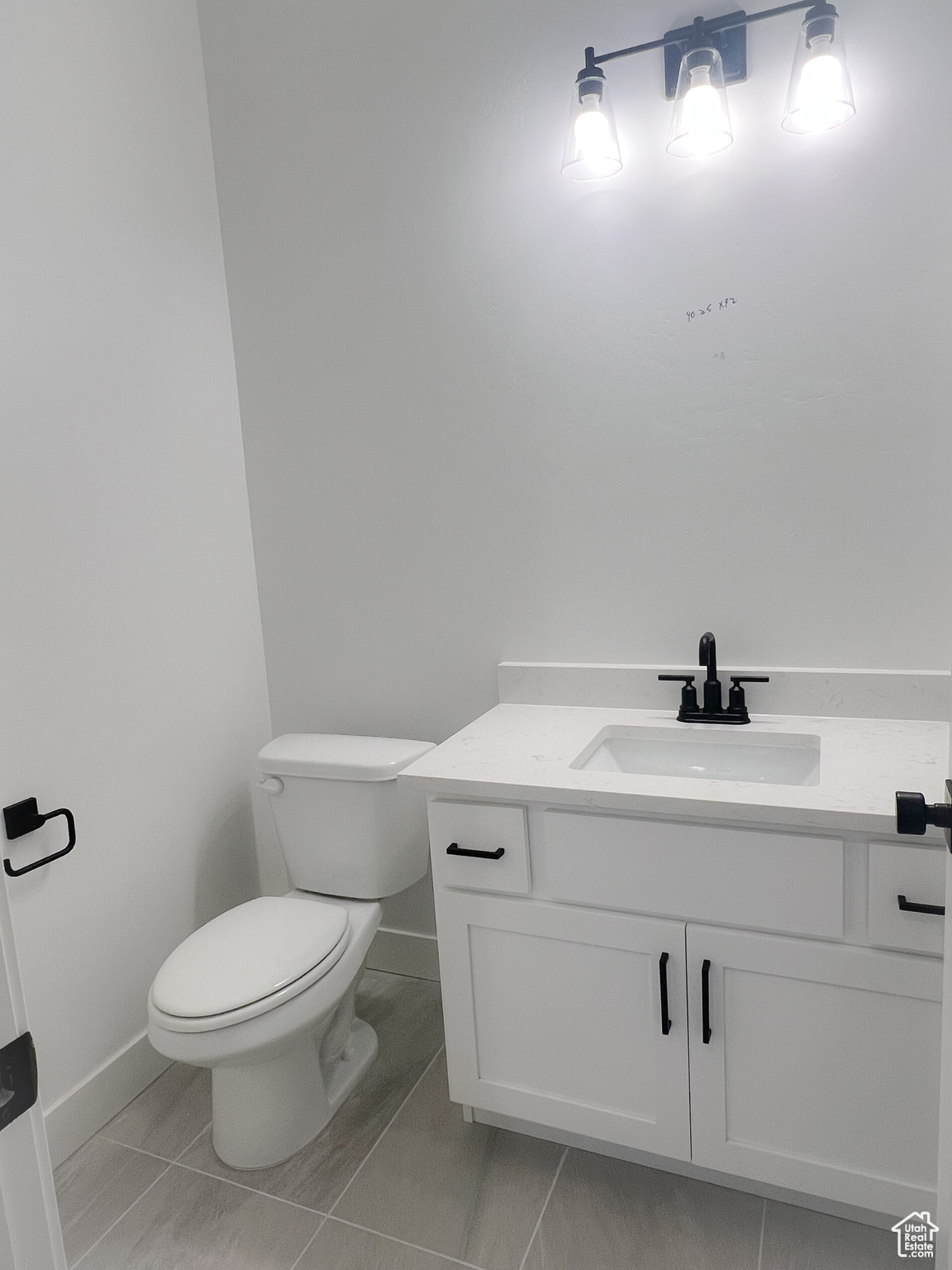 Bathroom with tile patterned floors, toilet, and vanity