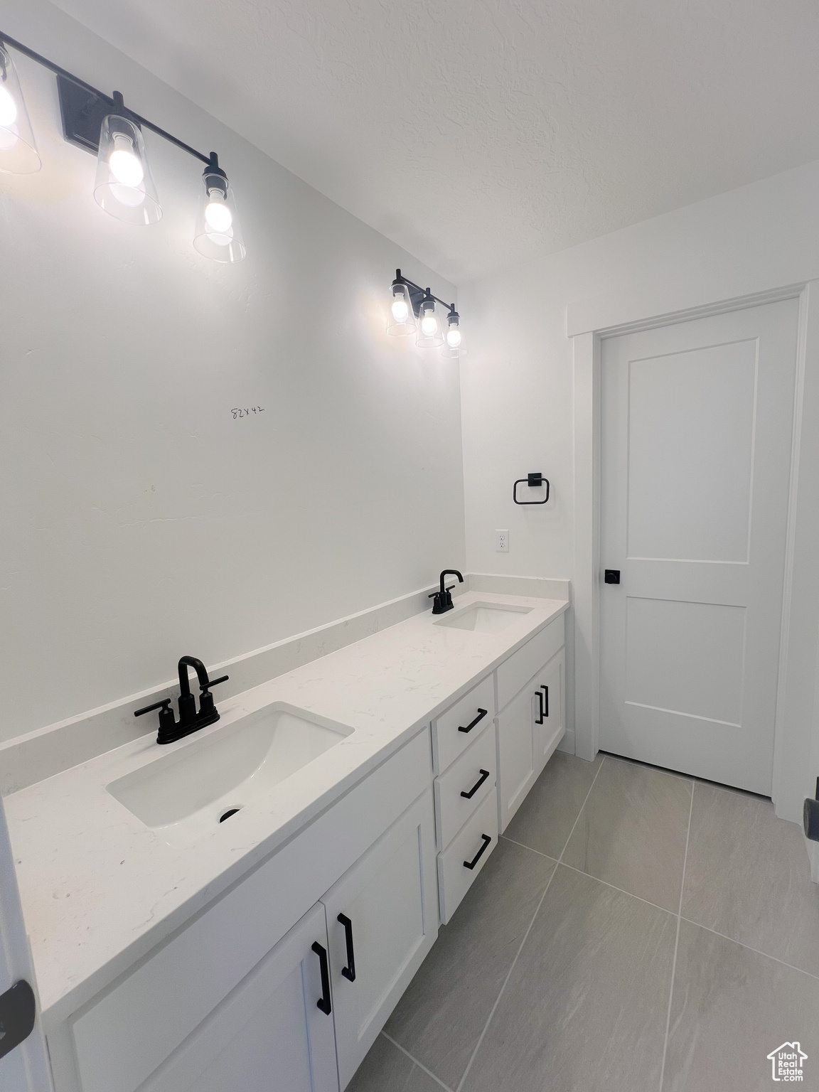 Bathroom featuring tile patterned flooring and vanity