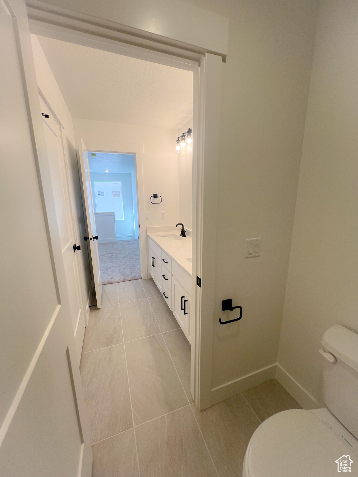 Bathroom with tile patterned flooring, toilet, and vanity