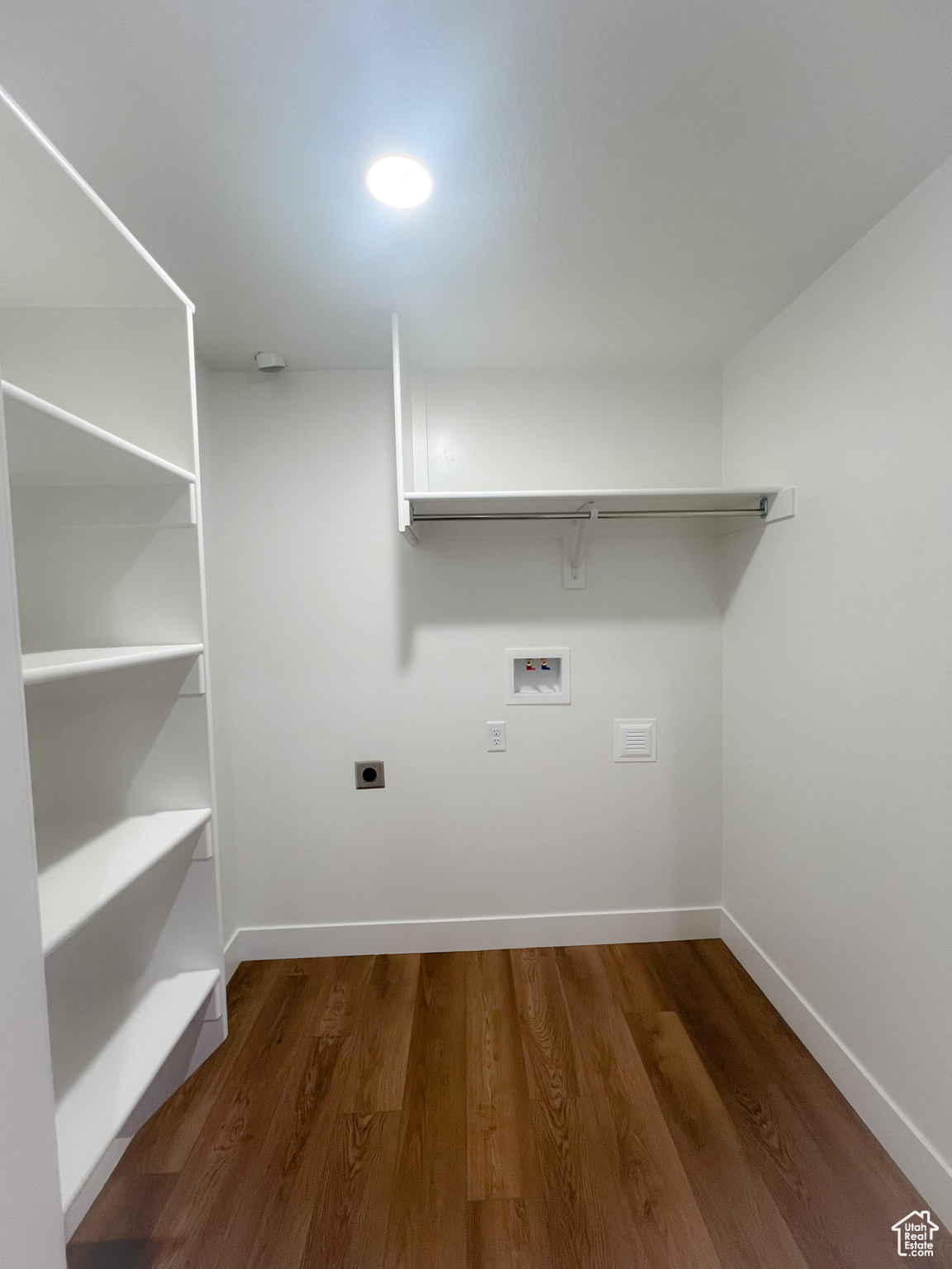 Washroom featuring hardwood / wood-style flooring, washer hookup, and hookup for an electric dryer