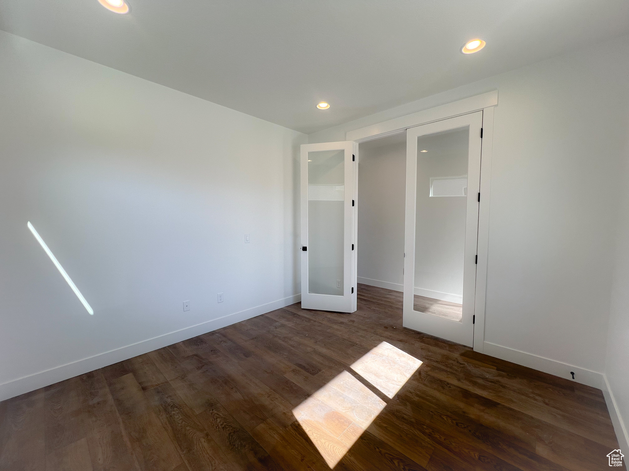 Unfurnished bedroom with a closet and hardwood / wood-style floors