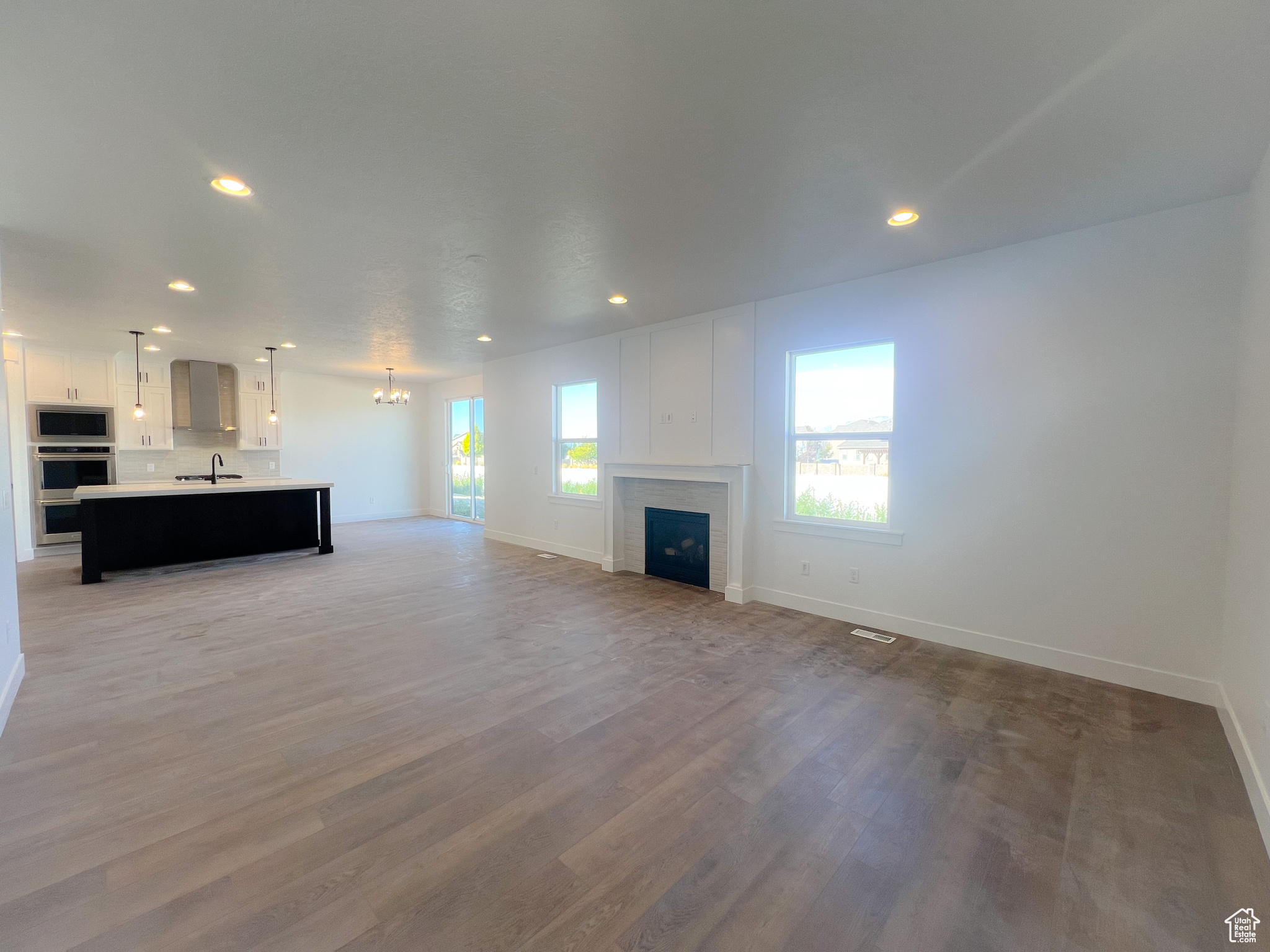 Unfurnished living room with light wood-type flooring and sink