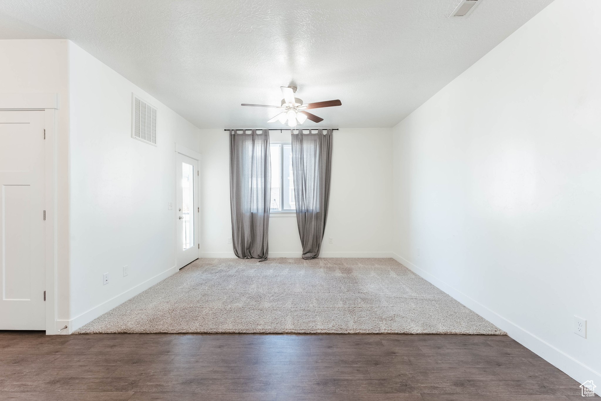 Unfurnished room with hardwood / wood-style flooring and ceiling fan