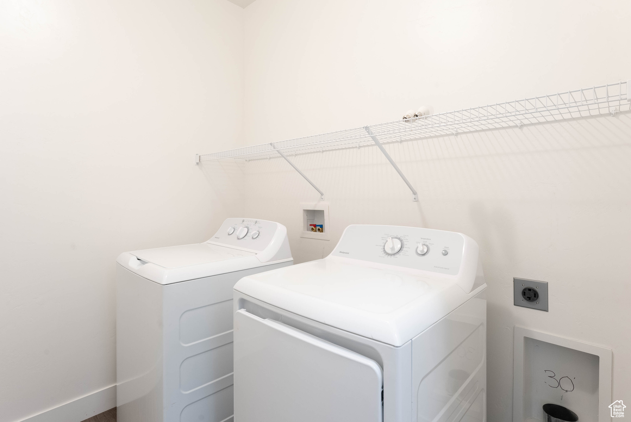 Washroom with washing machine and clothes dryer