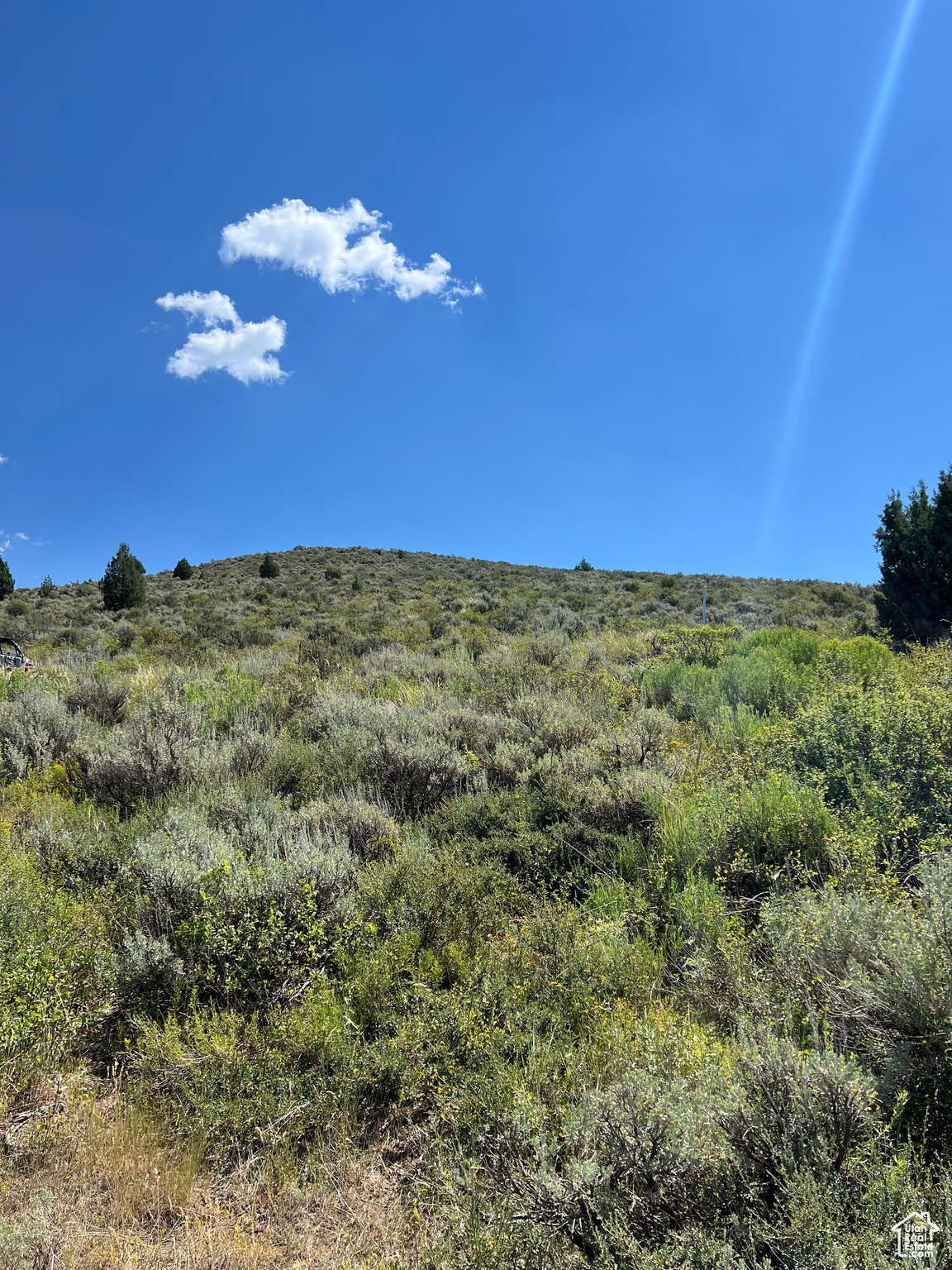 Looking East over the property. / The slope is ideal for building on or creating a pad for an RV