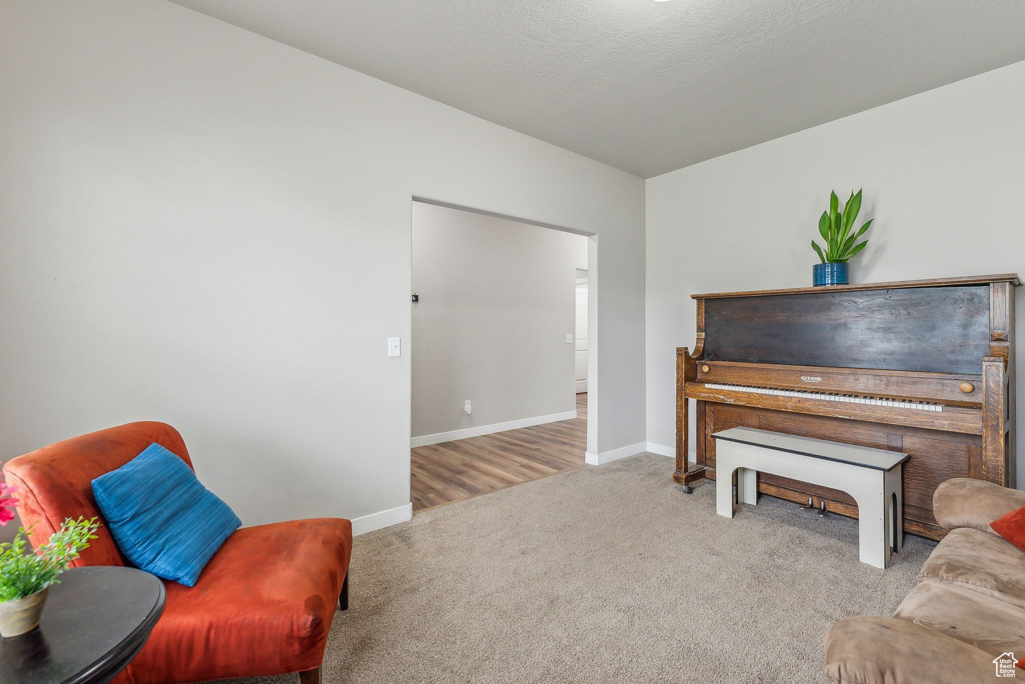 Sitting room featuring light colored carpet