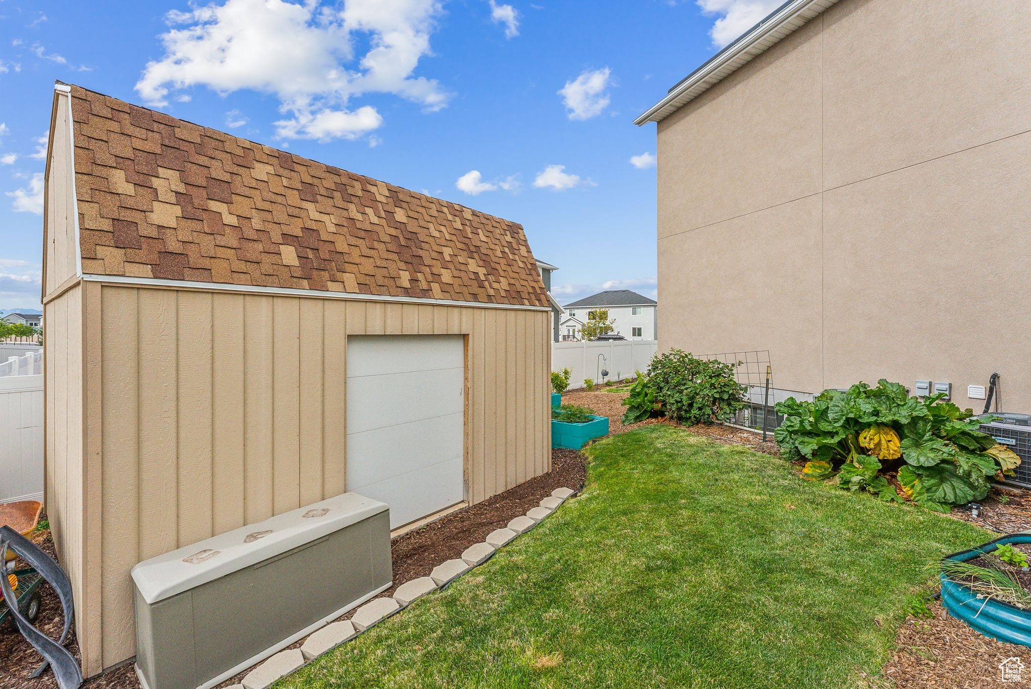 Garage featuring a lawn