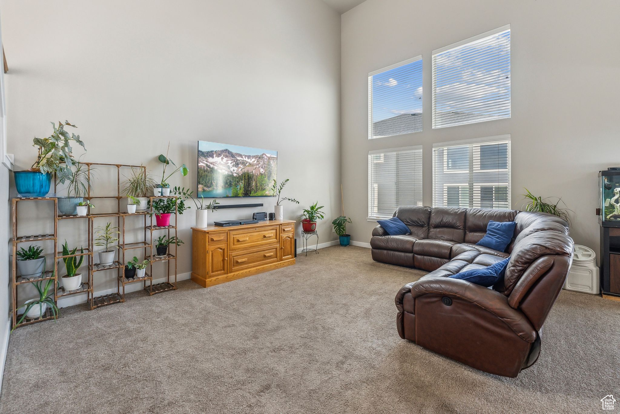 Living room with a towering ceiling and carpet floors