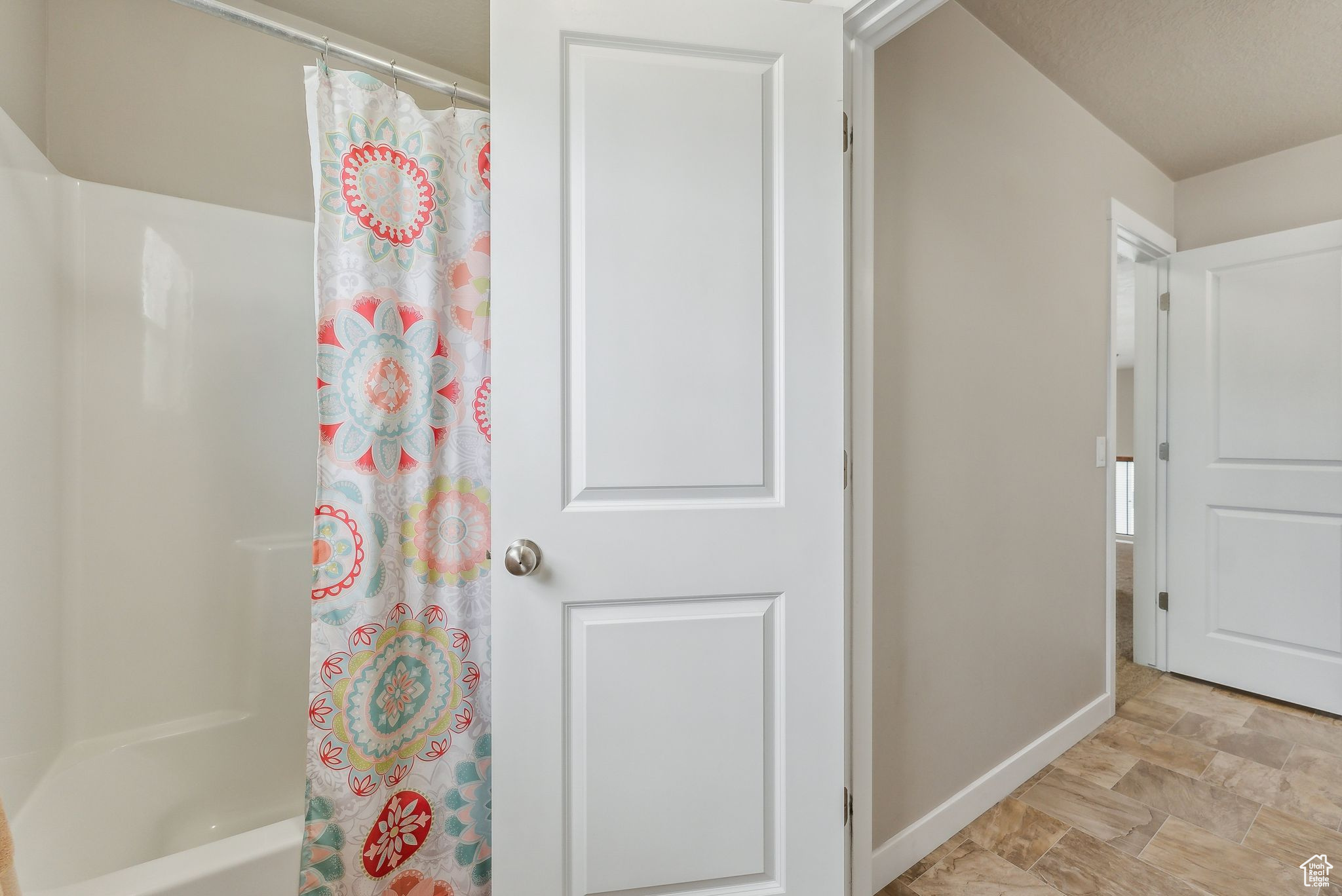 Bathroom featuring shower / bath combo and tile patterned floors