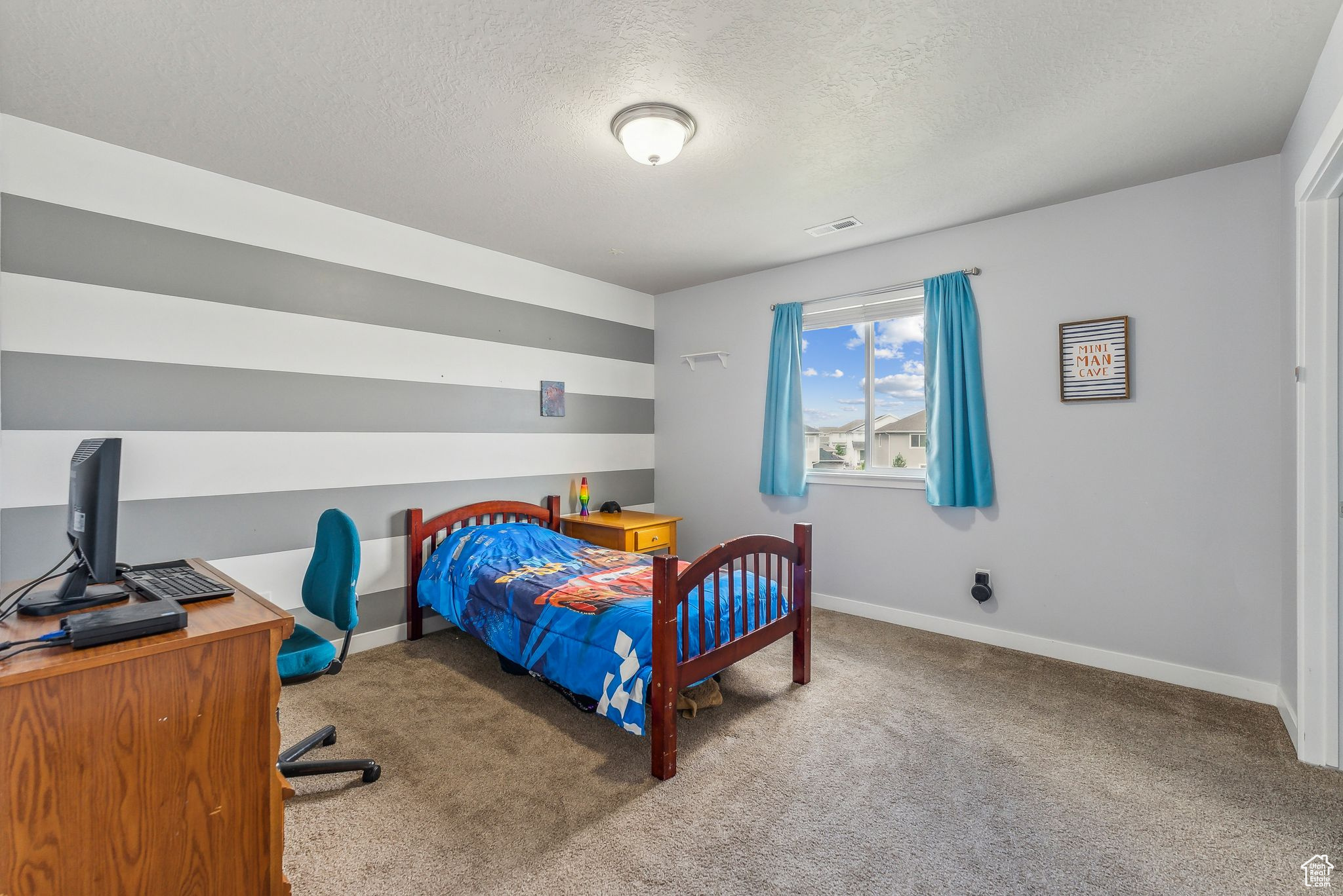 Carpeted bedroom with a textured ceiling