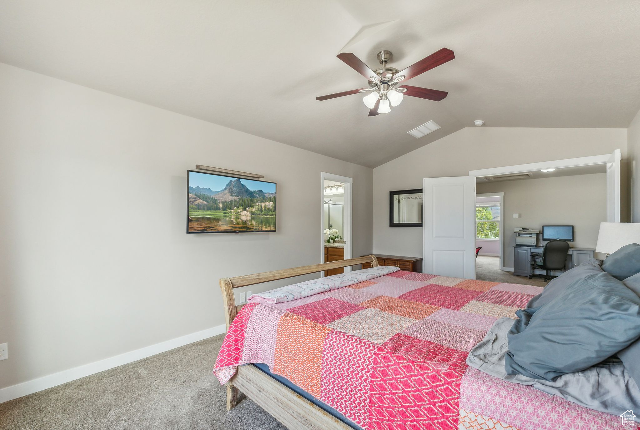 Bedroom with ceiling fan, vaulted ceiling, and carpet