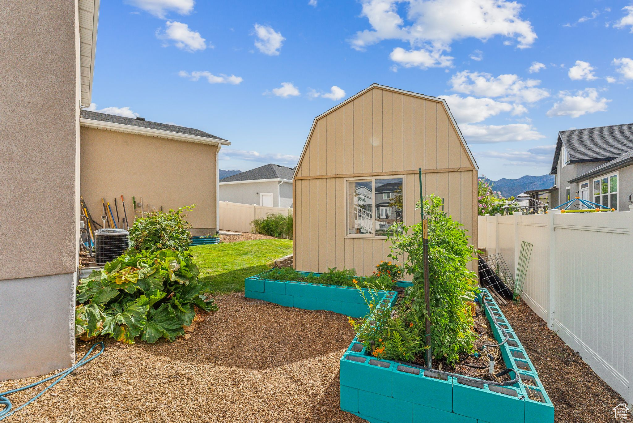 Exterior space with a mountain view, an outdoor structure, and cooling unit