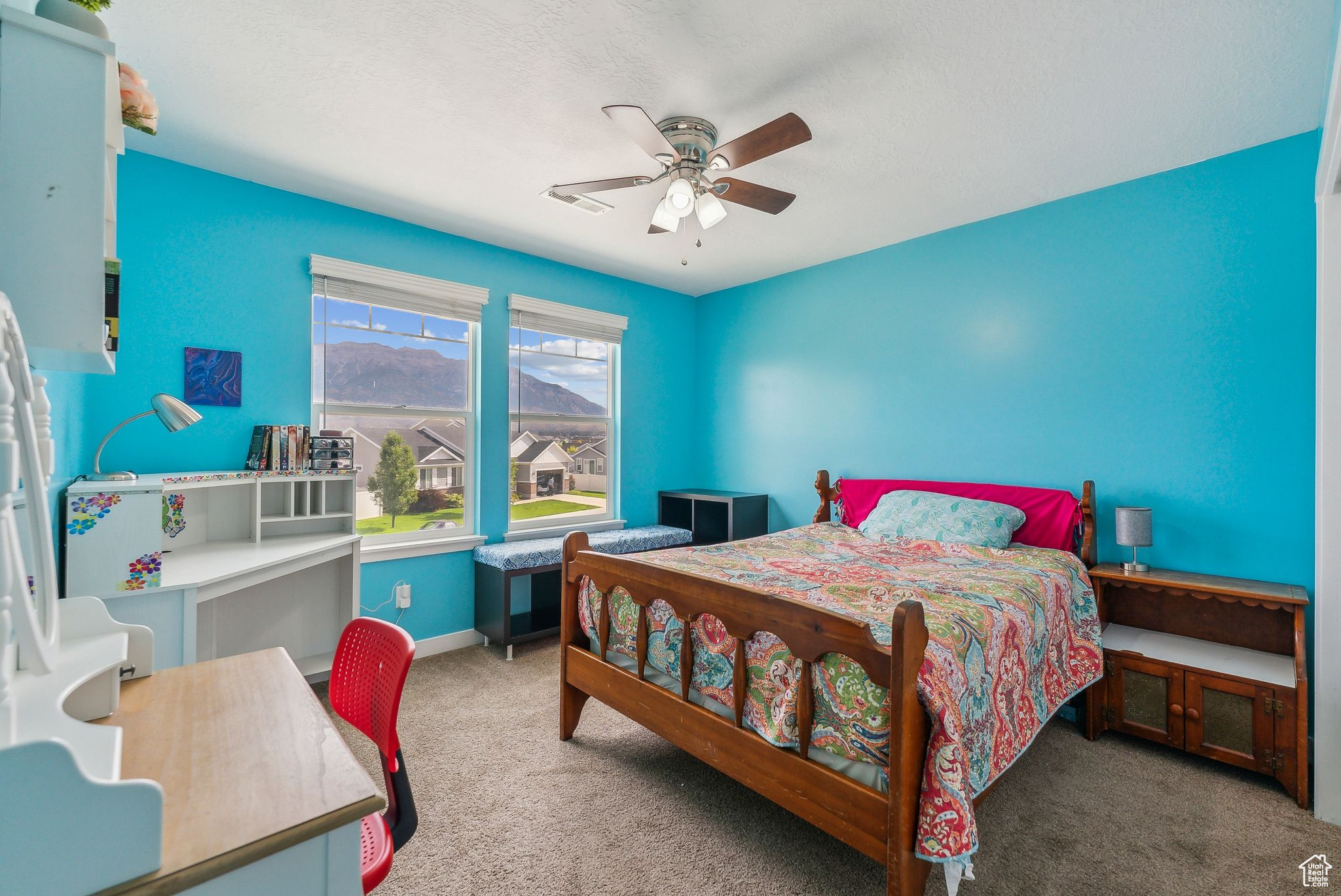 Carpeted bedroom with ceiling fan