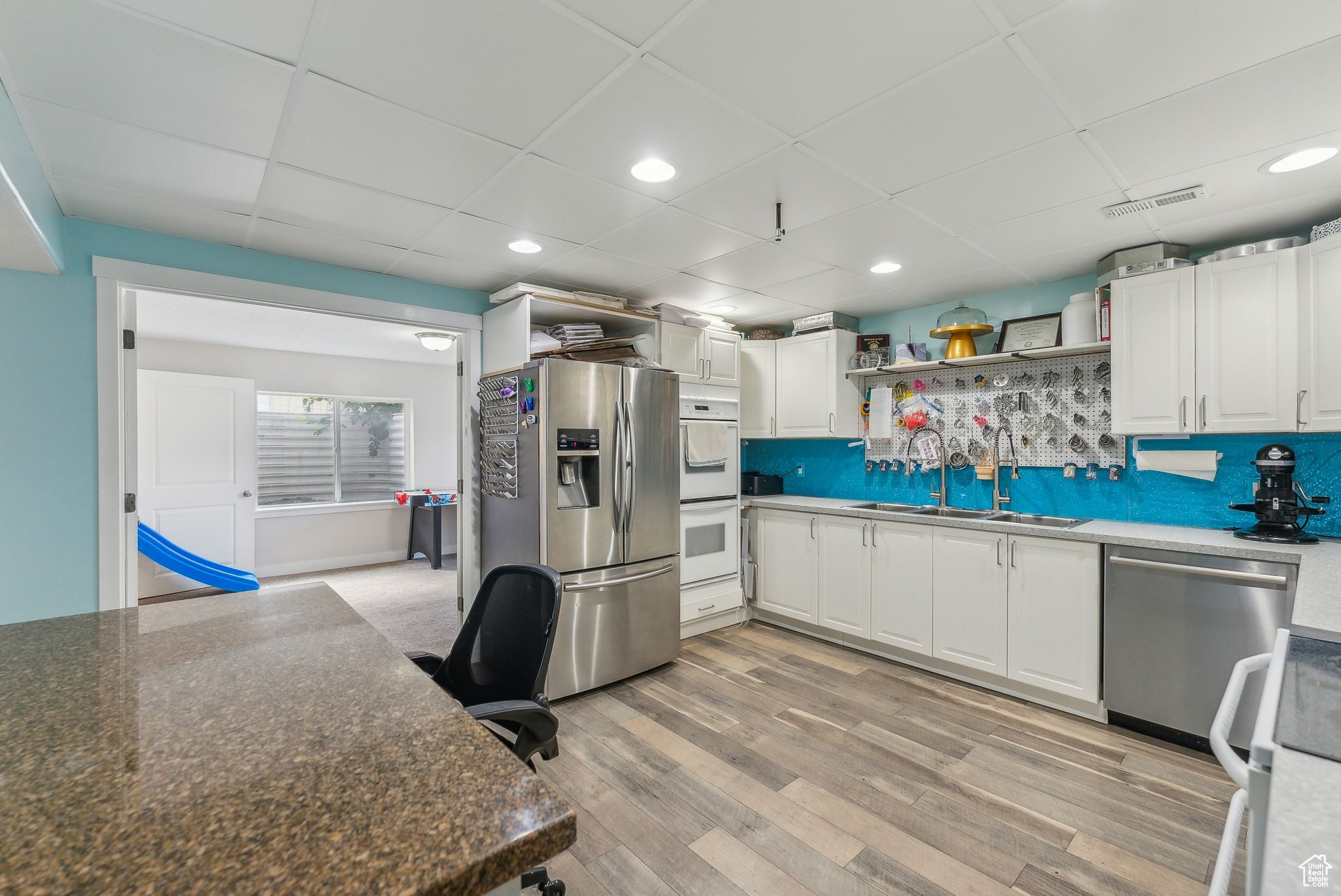 Kitchen featuring white cabinetry, appliances with stainless steel finishes, sink, and light hardwood / wood-style flooring