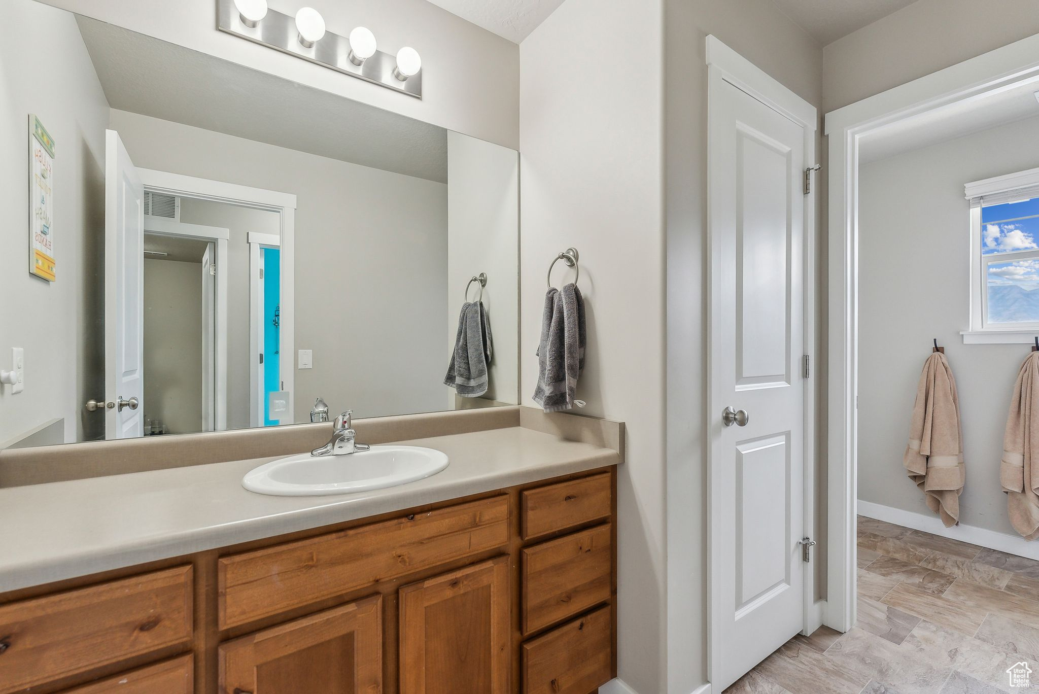 Bathroom featuring tile patterned flooring and vanity