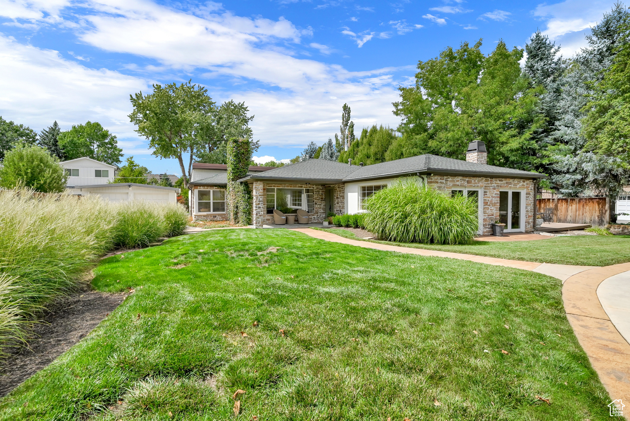 Single story home featuring a front yard and a garage