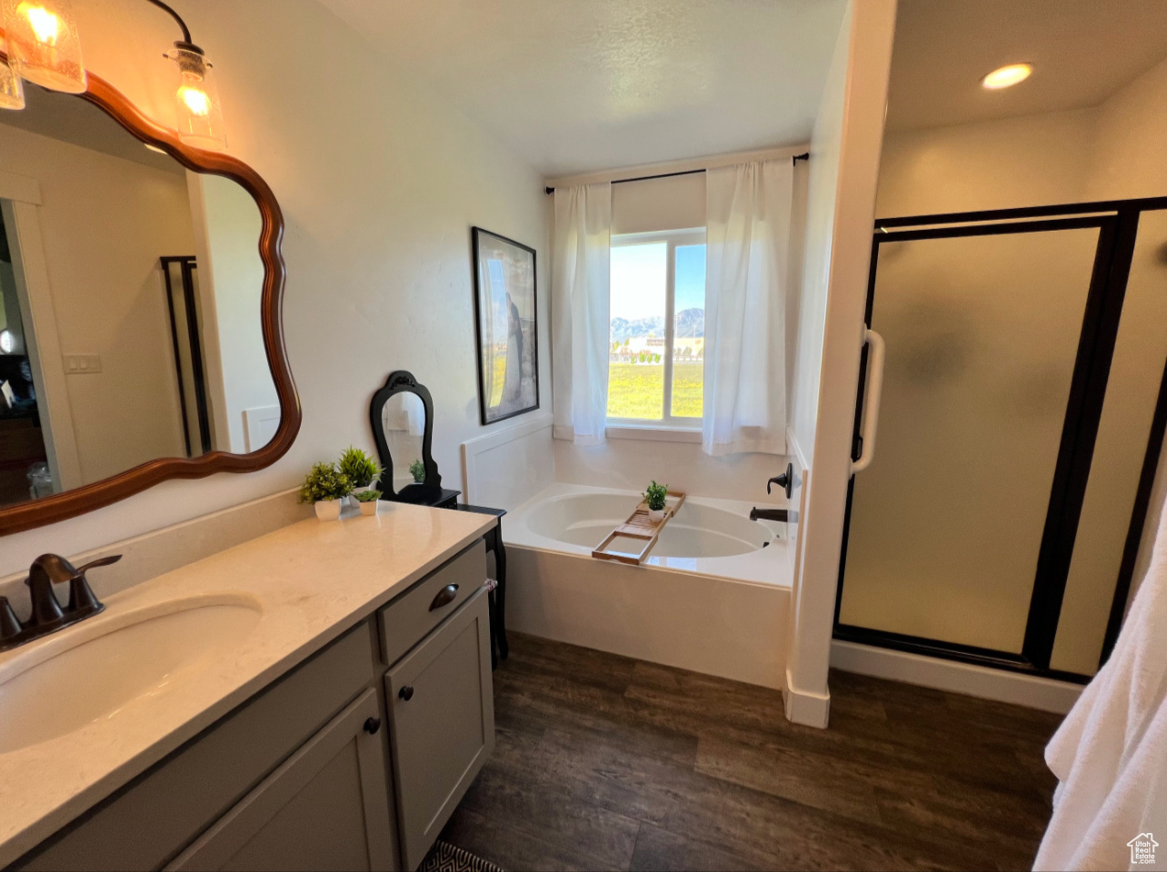 Primary Bathroom with grab bars, separate shower and garden tub