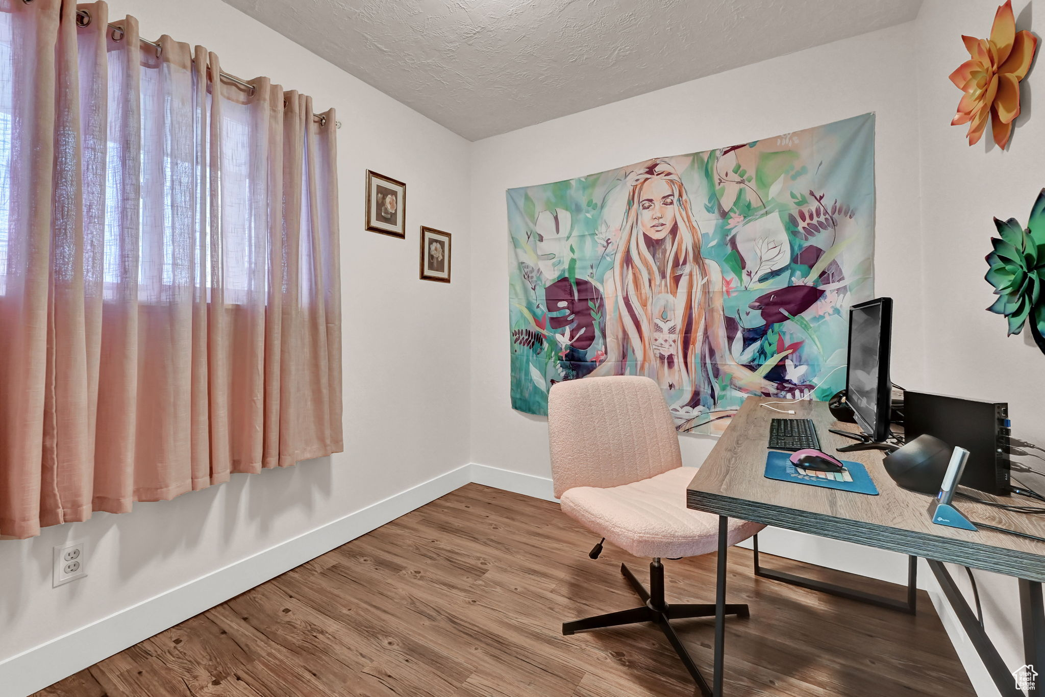 Office featuring a textured ceiling and wood-type flooring