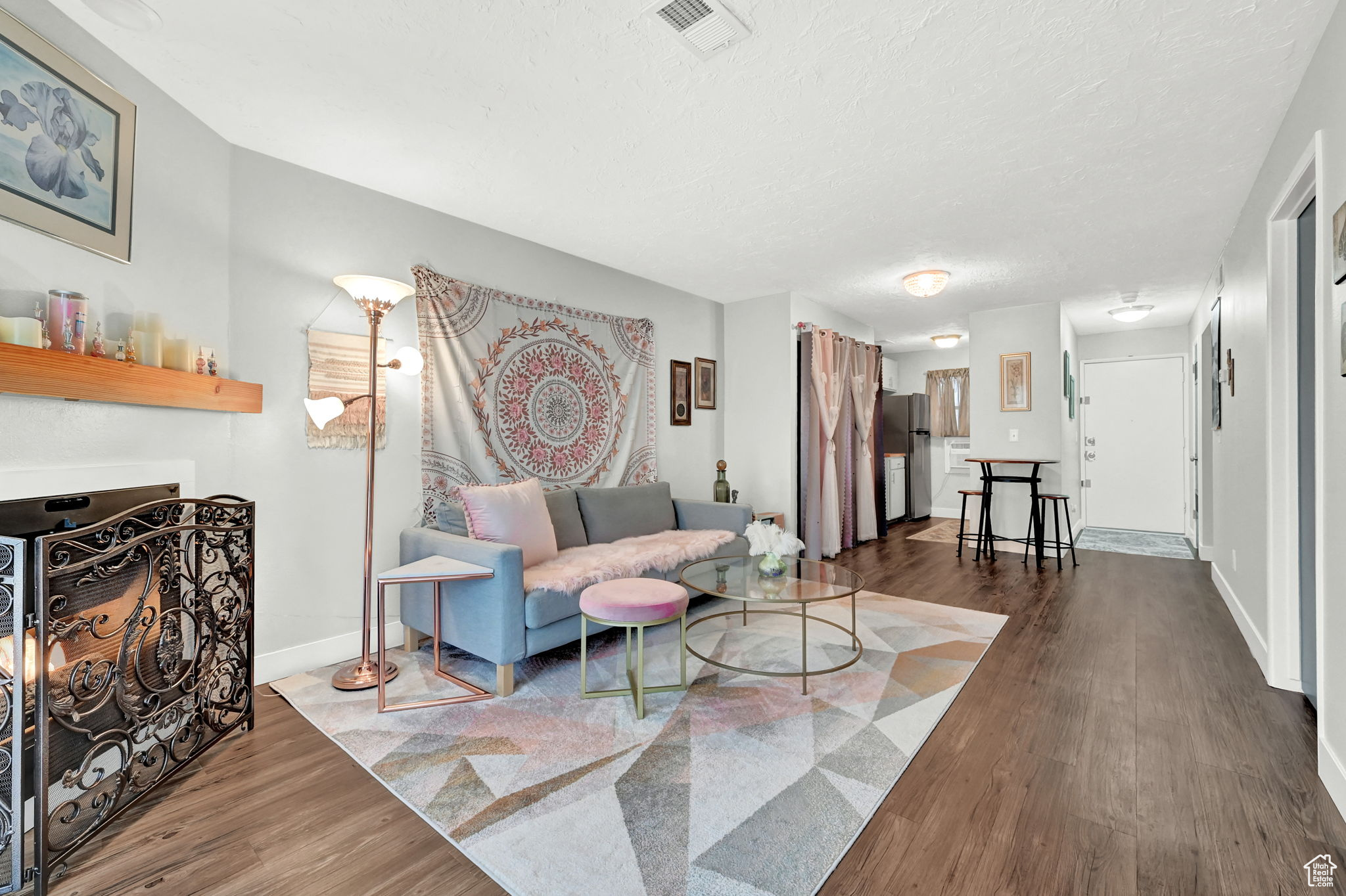 Living room with dark wood-type flooring and a textured ceiling