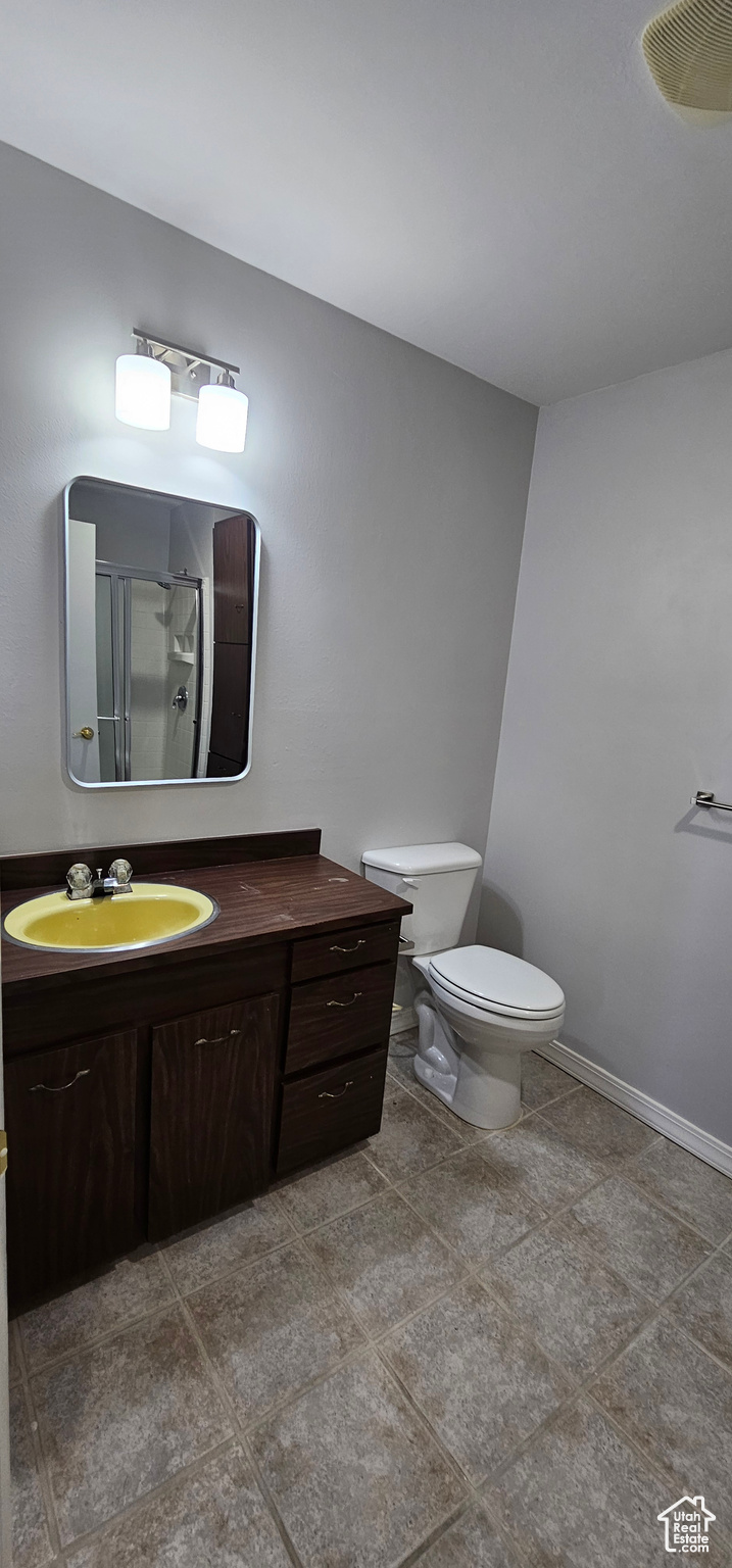 Bathroom with walk in shower, vanity, and toilet