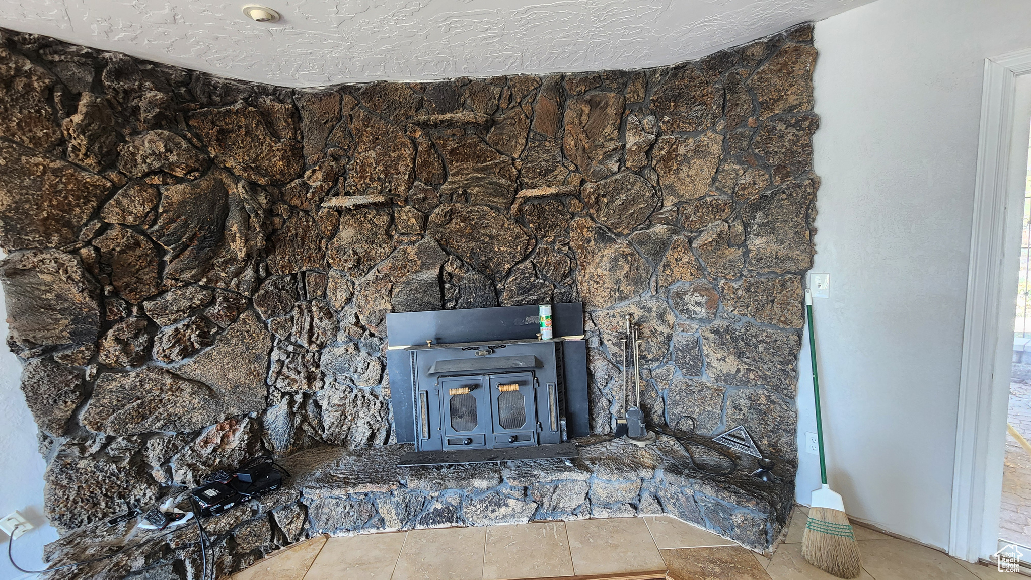 Details featuring a textured ceiling and tile patterned floors