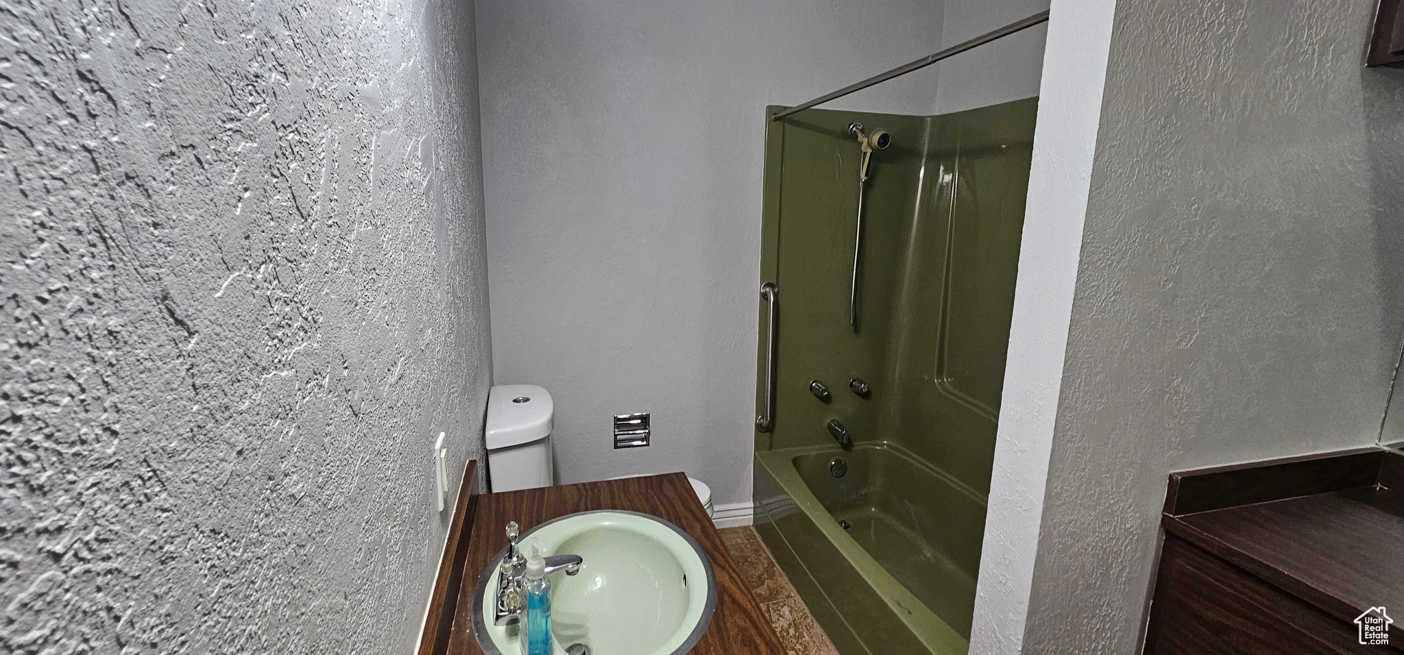 Full bathroom with bathing tub / shower combination, vanity, toilet, and hardwood / wood-style flooring