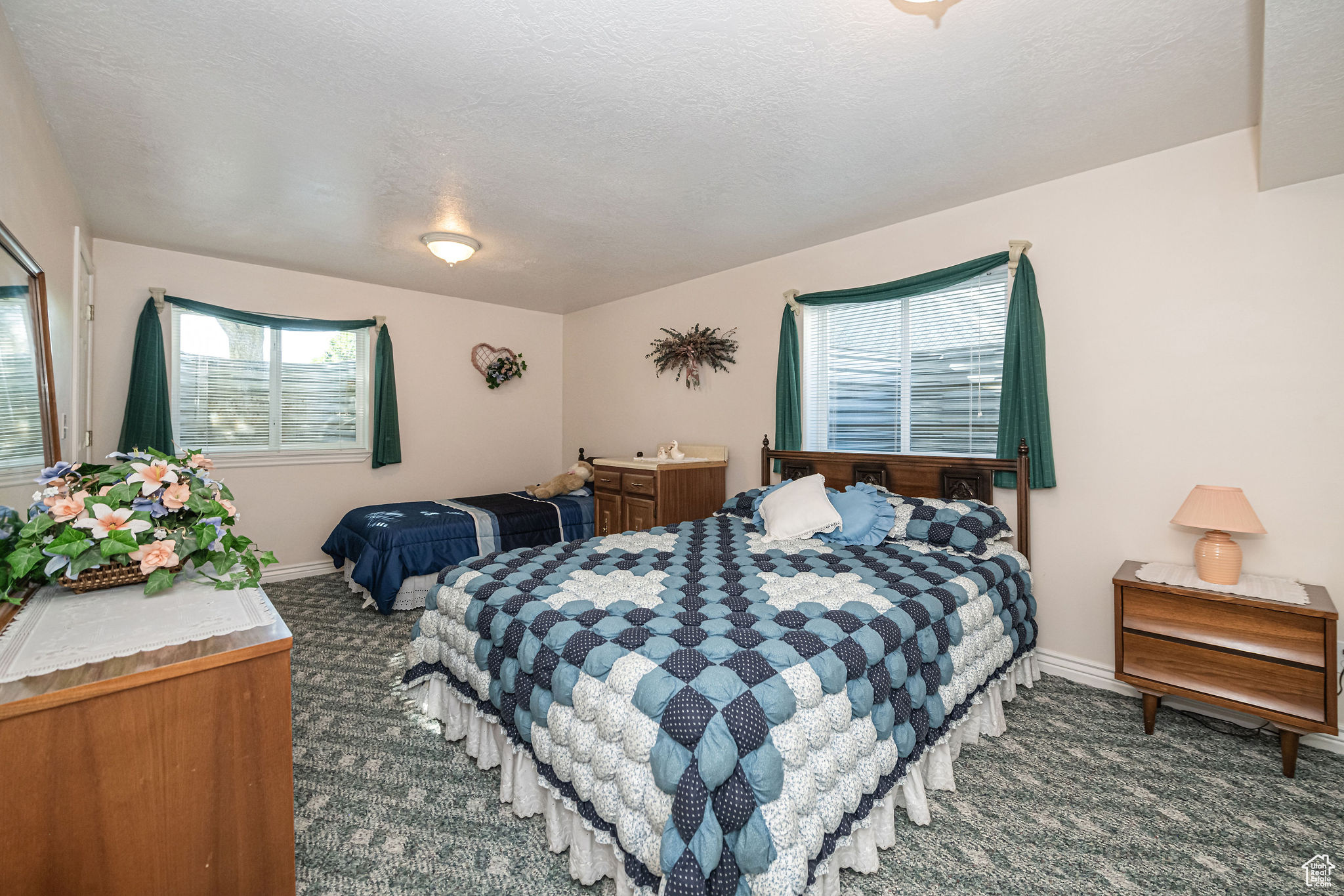 Carpeted bedroom with a textured ceiling