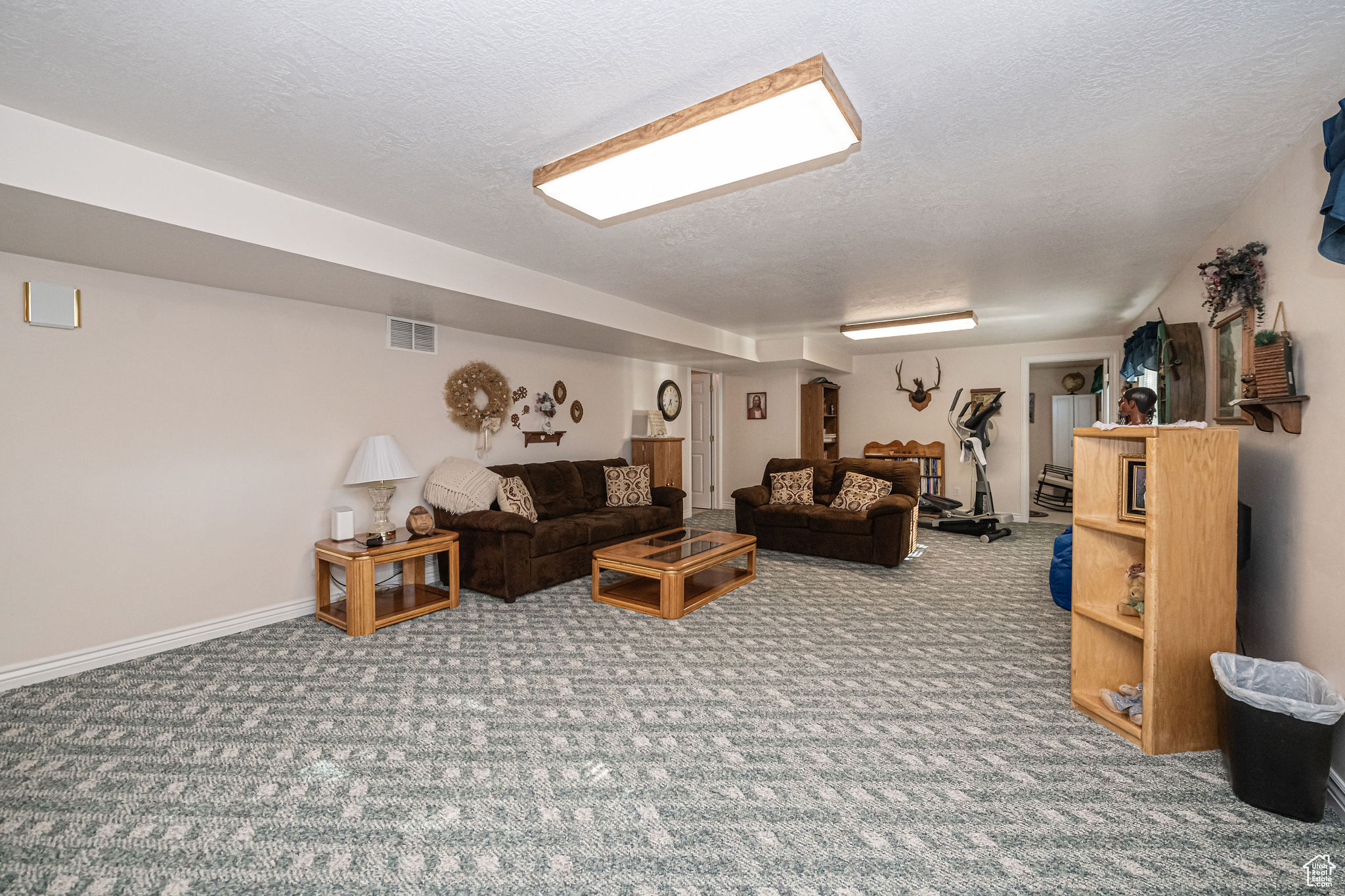 Carpeted living room with a textured ceiling