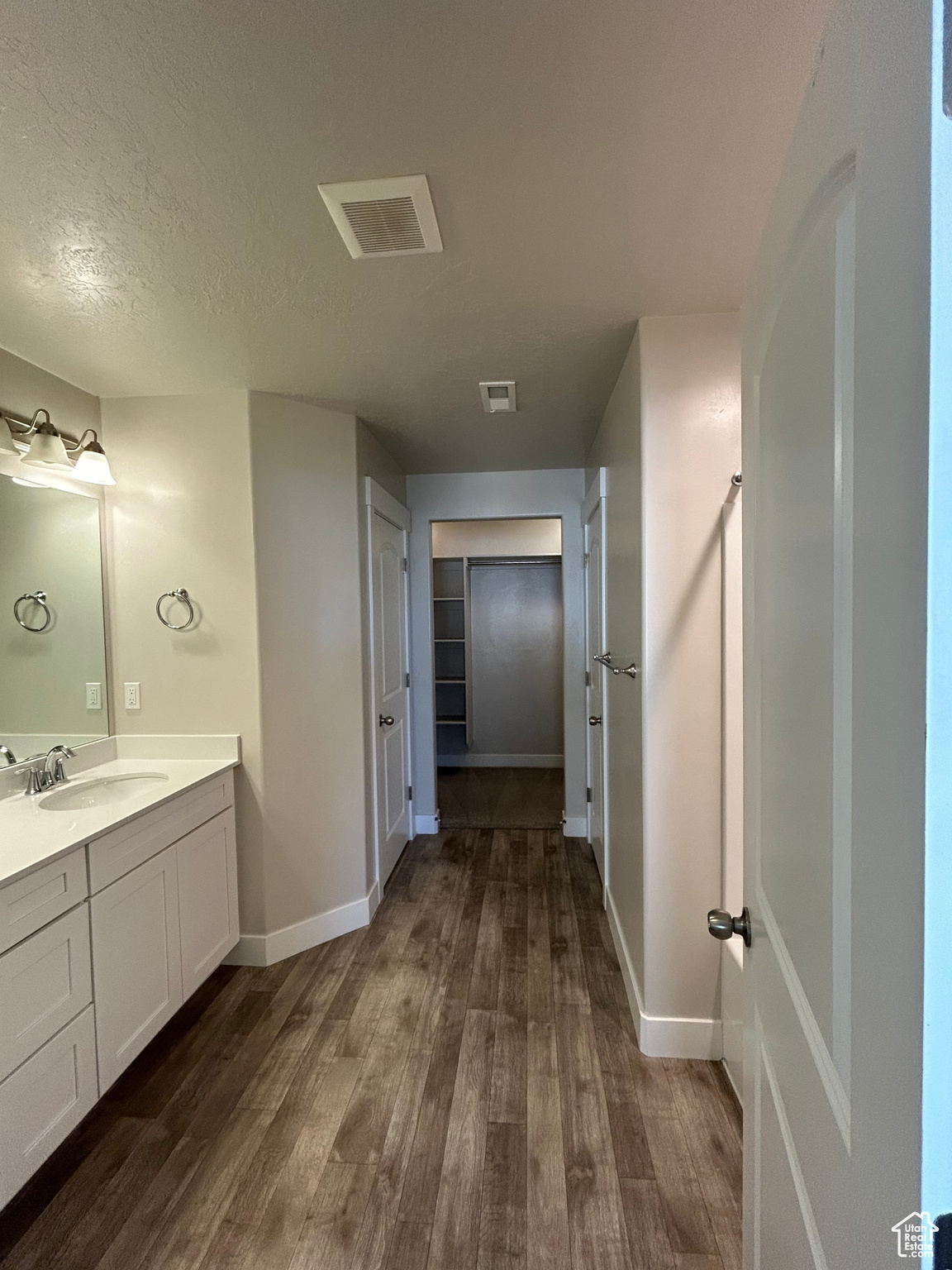 Large primary bathroom featuring double vanity, separate tub/shower, and walk in closet,