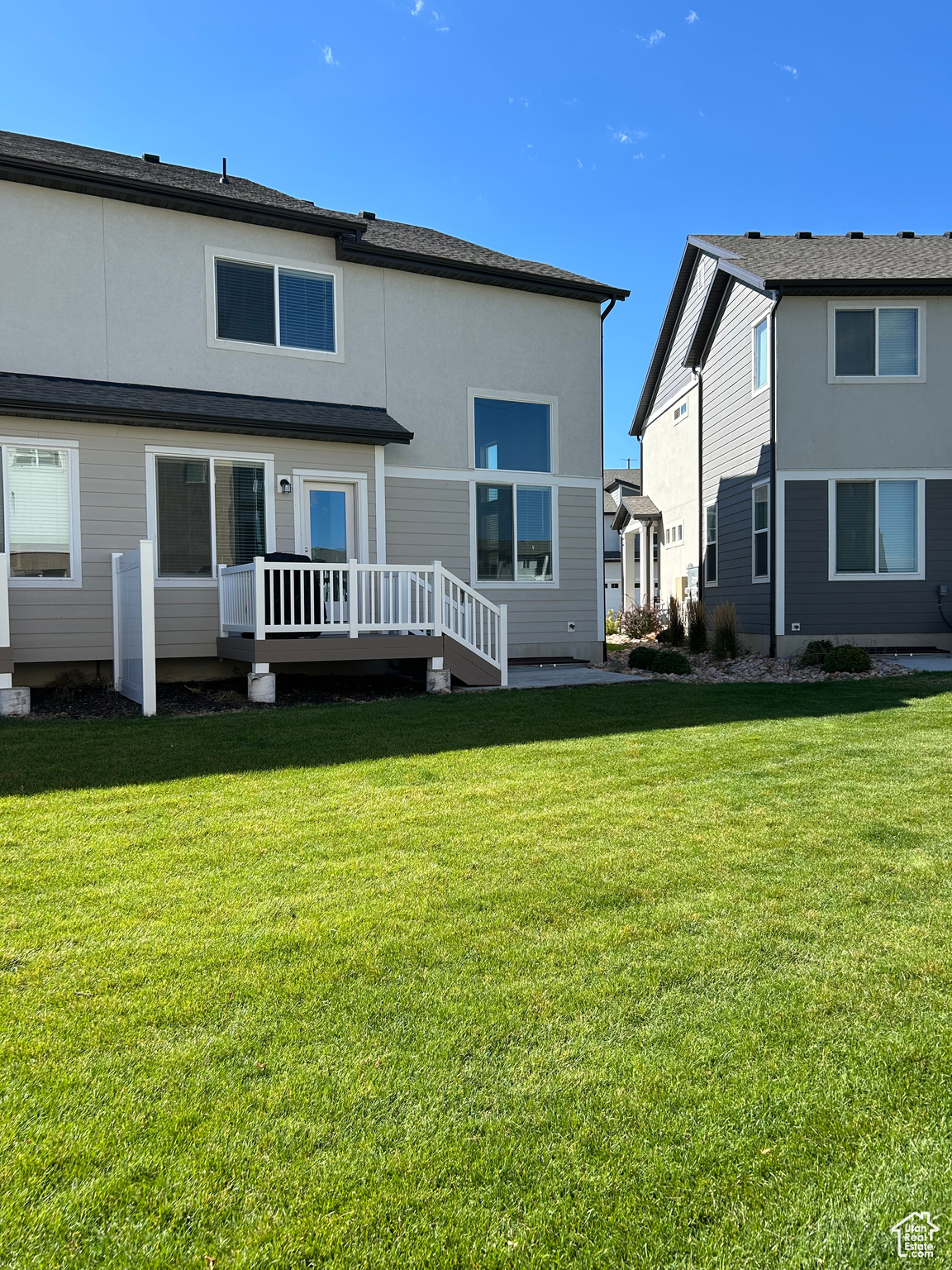 Back of house featuring a yard and a deck