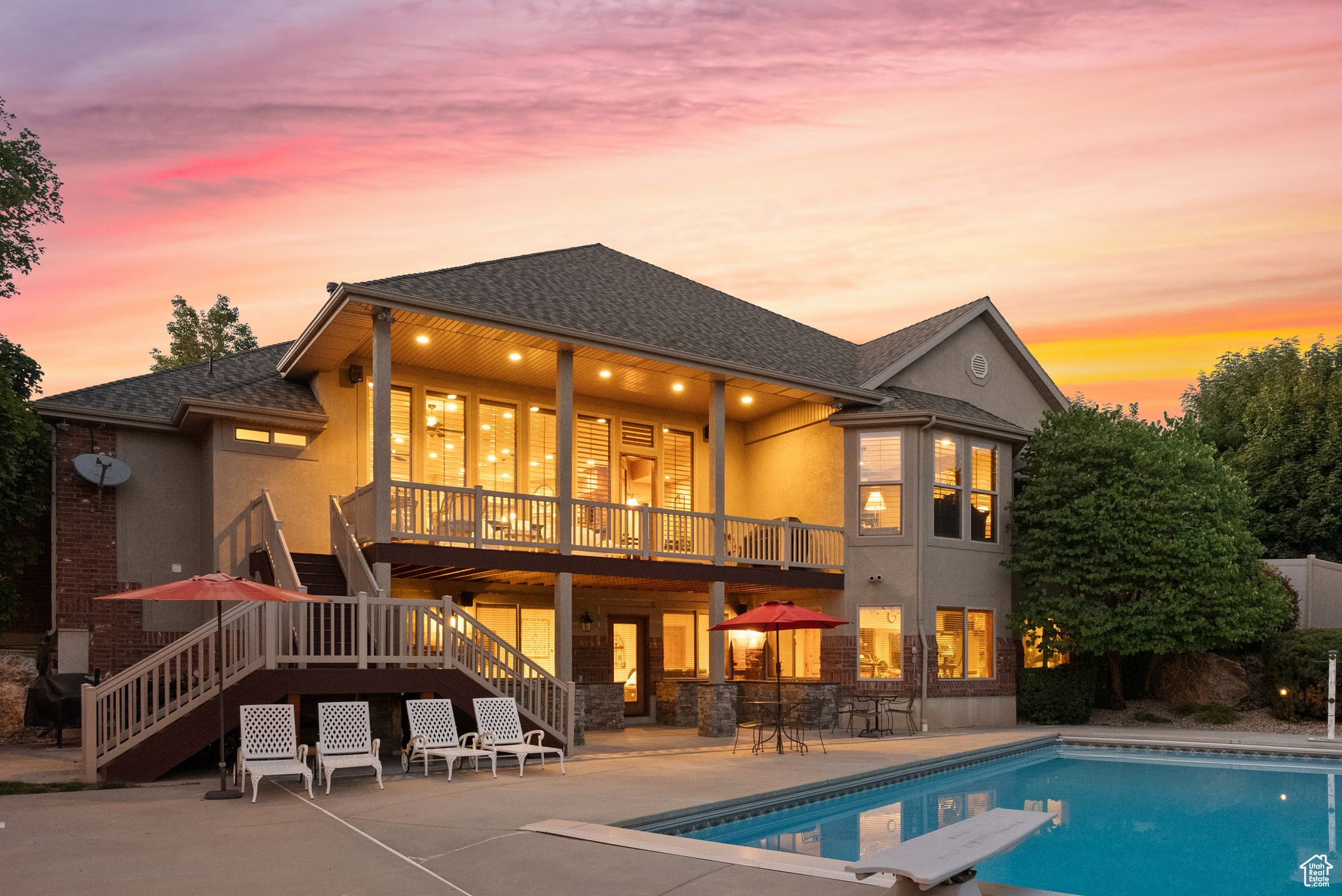 Back house at dusk featuring a patio