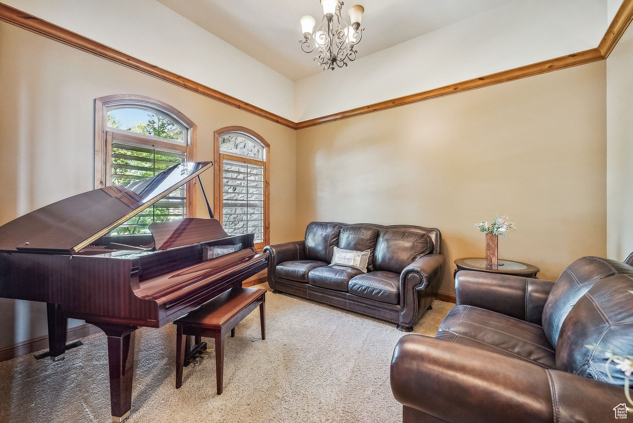 Carpeted living room with a chandelier