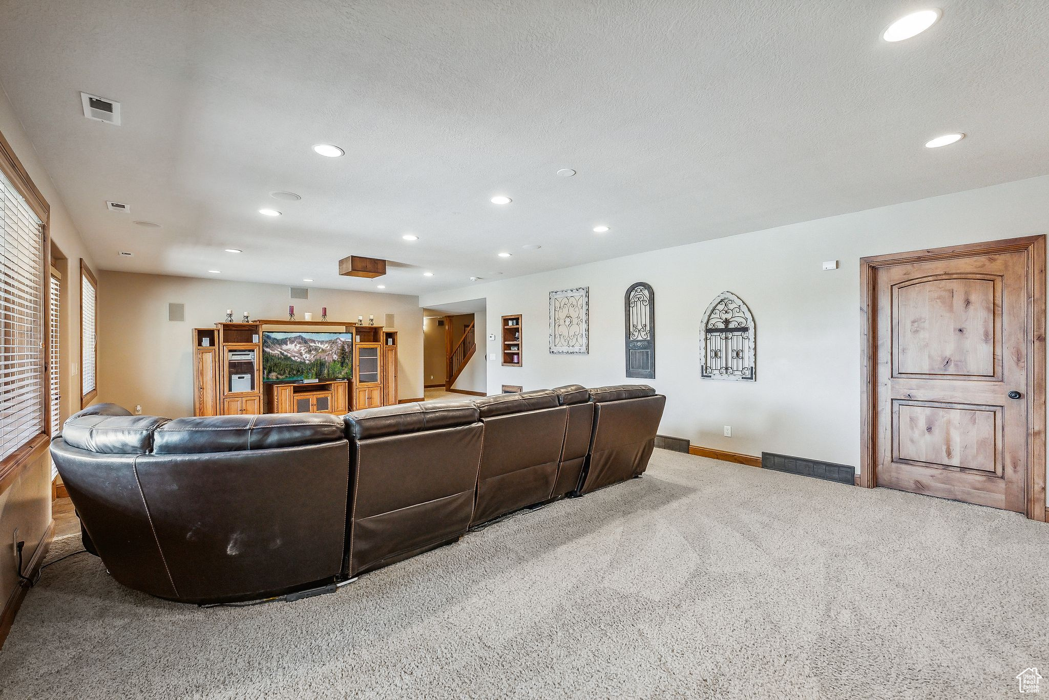 Living room featuring light carpet and a textured ceiling