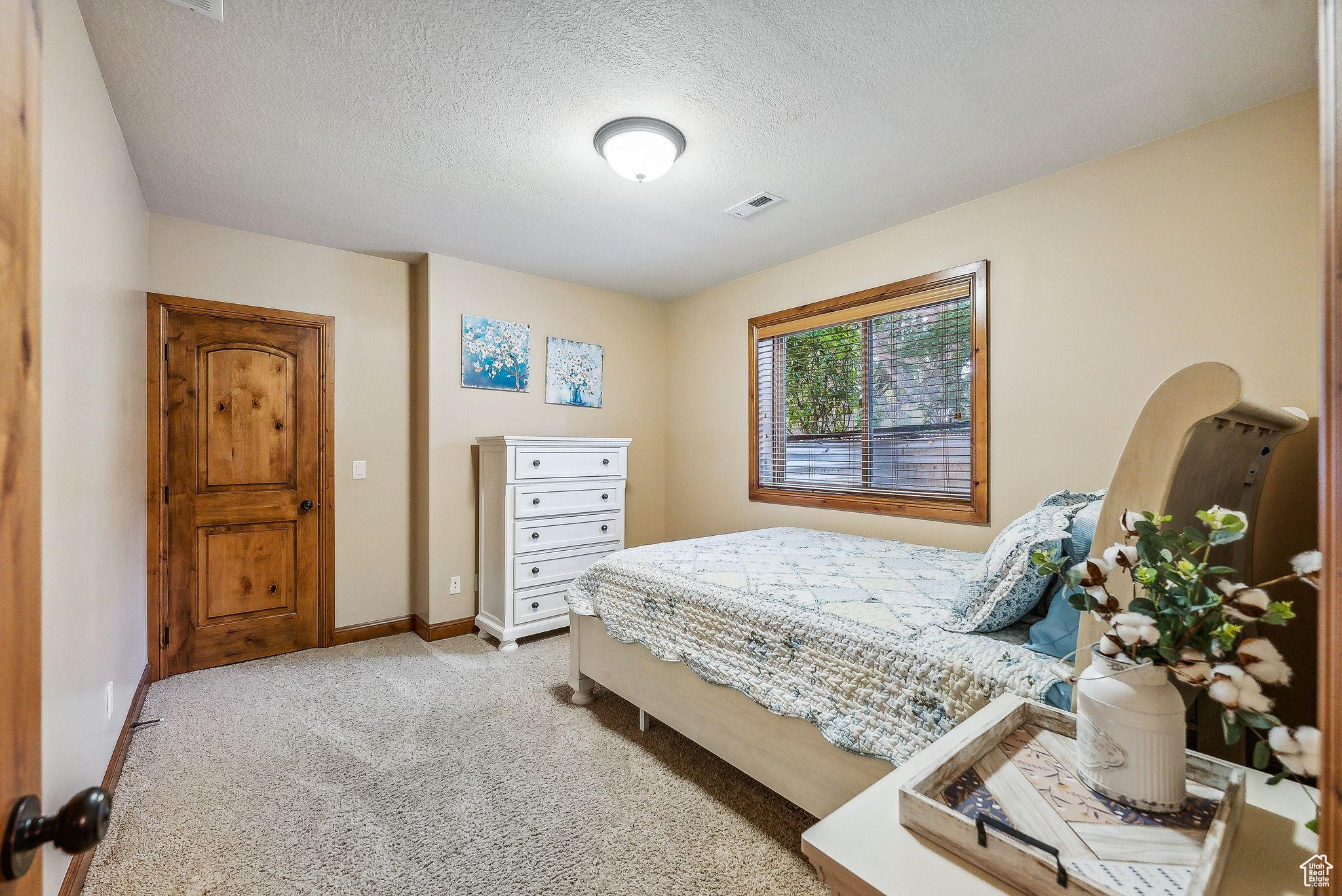 Carpeted bedroom with a textured ceiling