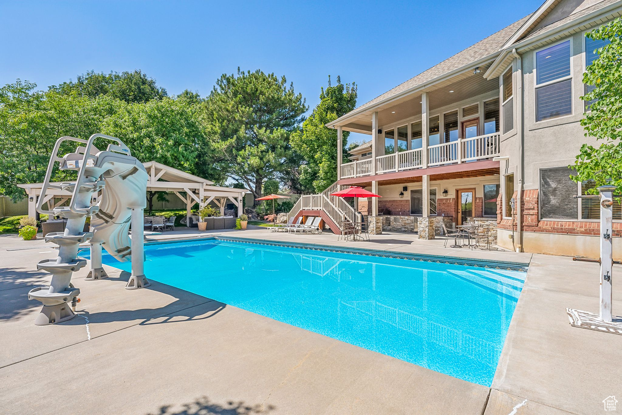 View of swimming pool featuring a water slide and a patio area