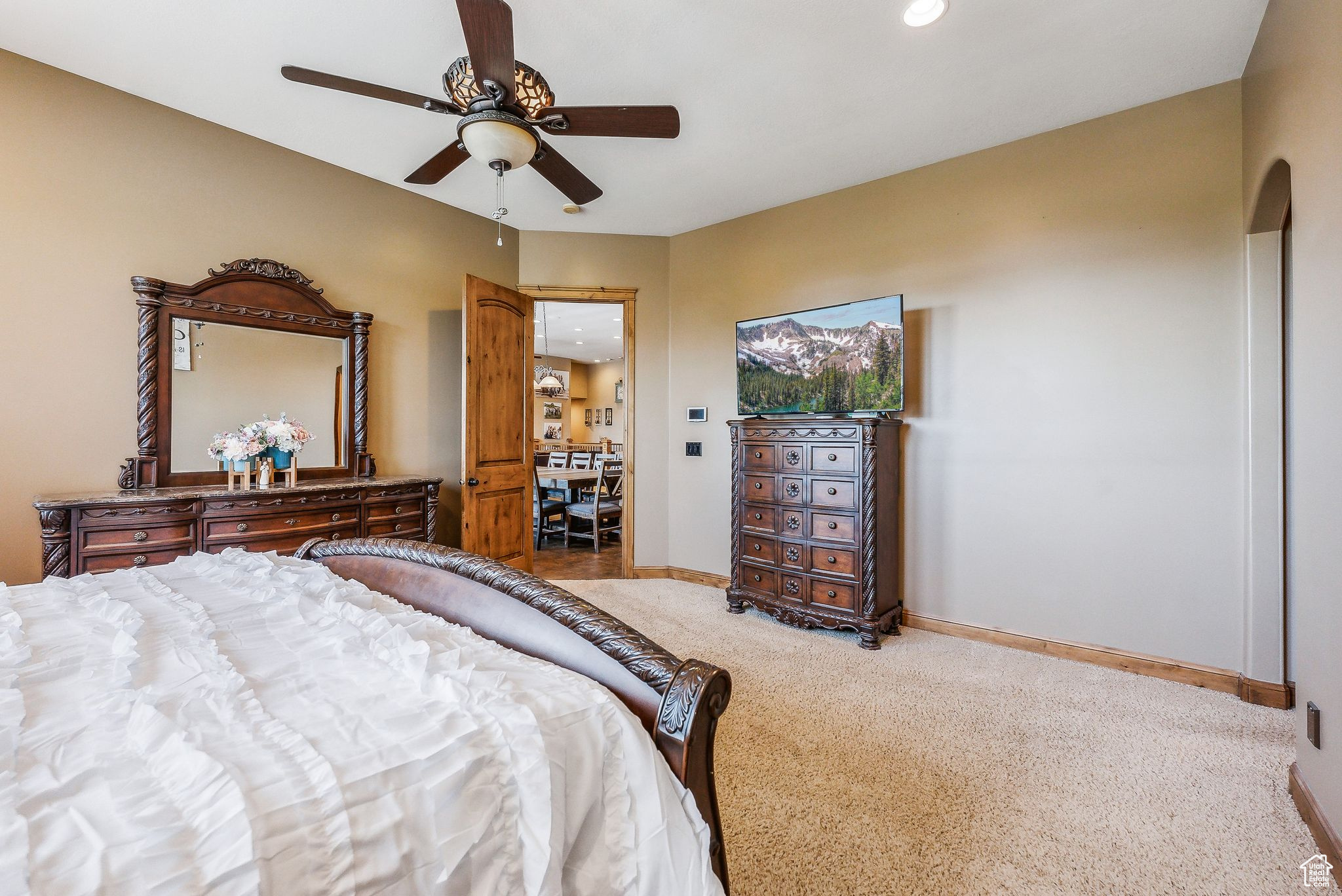 Carpeted bedroom with ceiling fan