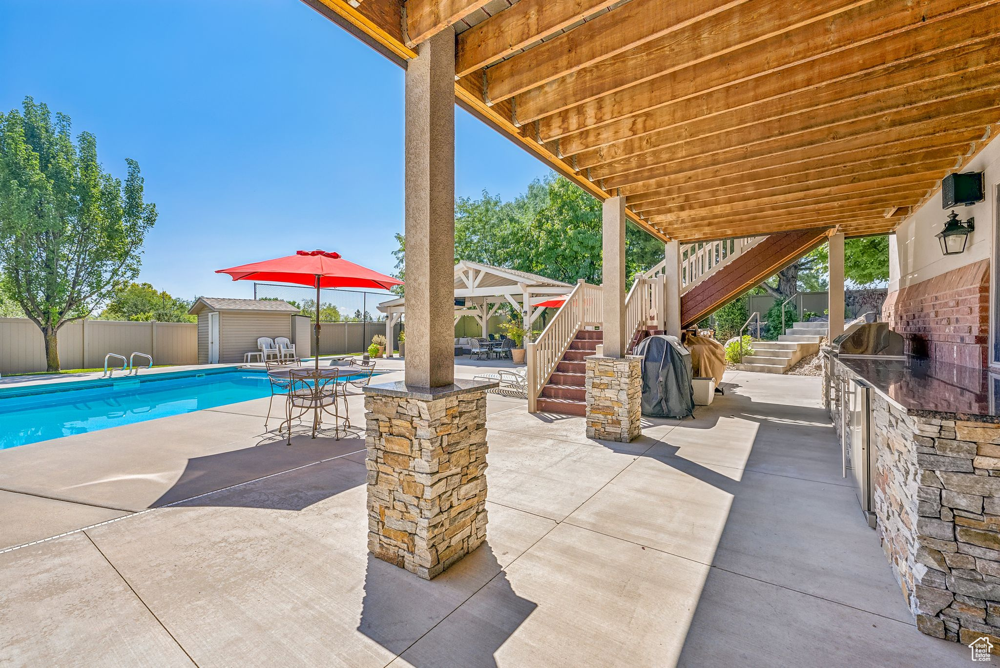 Exterior space featuring a shed and a patio